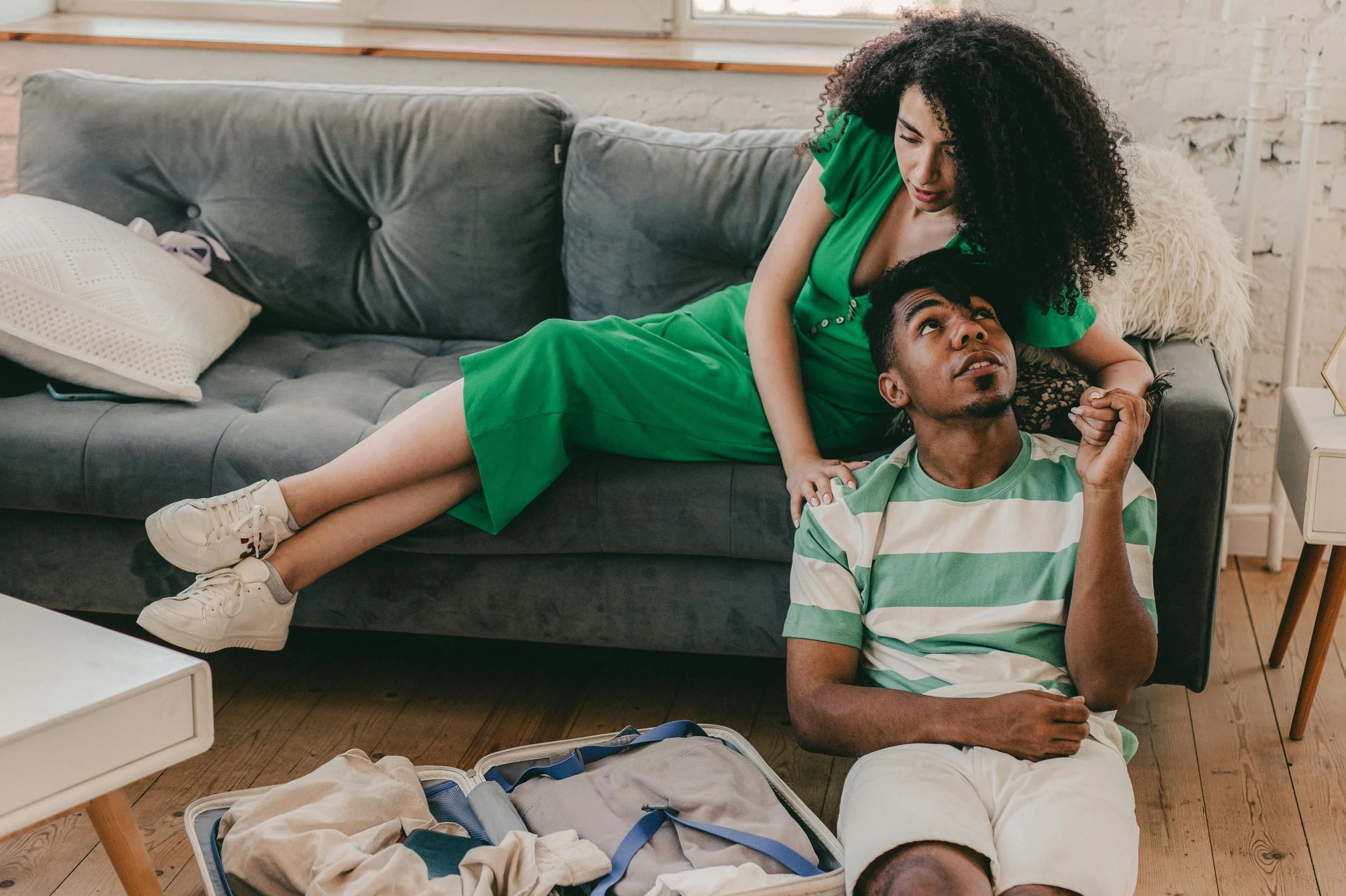 A couple sitting closely together on a couch, representing therapy support for adults and couples in Connecticut