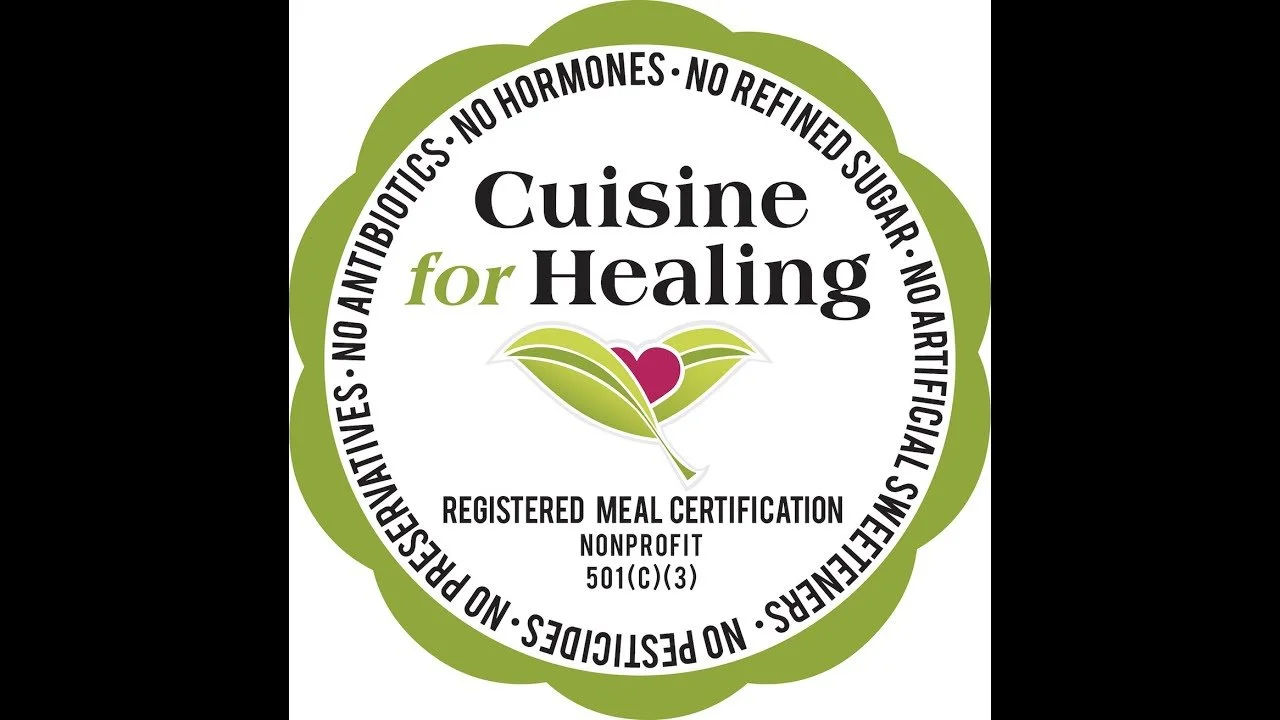 A circular logo with a green border and the words "Cuisine for Healing" in the center, featuring a stylized leaf and heart logo, and surrounded by text emphasizing natural, non-GMO, non-processed, and allergen-free food certifications.