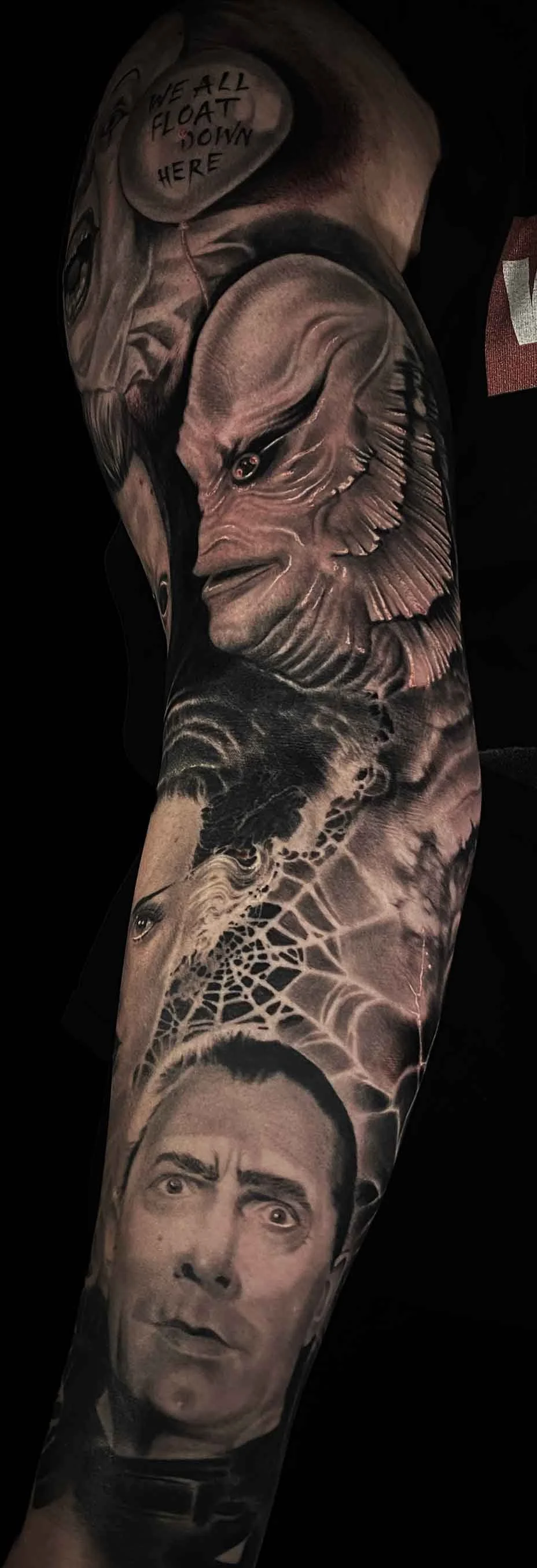 a black and grey arm sleeve horror portrait tattoo featuring the creature from the black lagoon, Frankenstein's bride, Michael Meyers and the original pennywise tattoo by Jewp