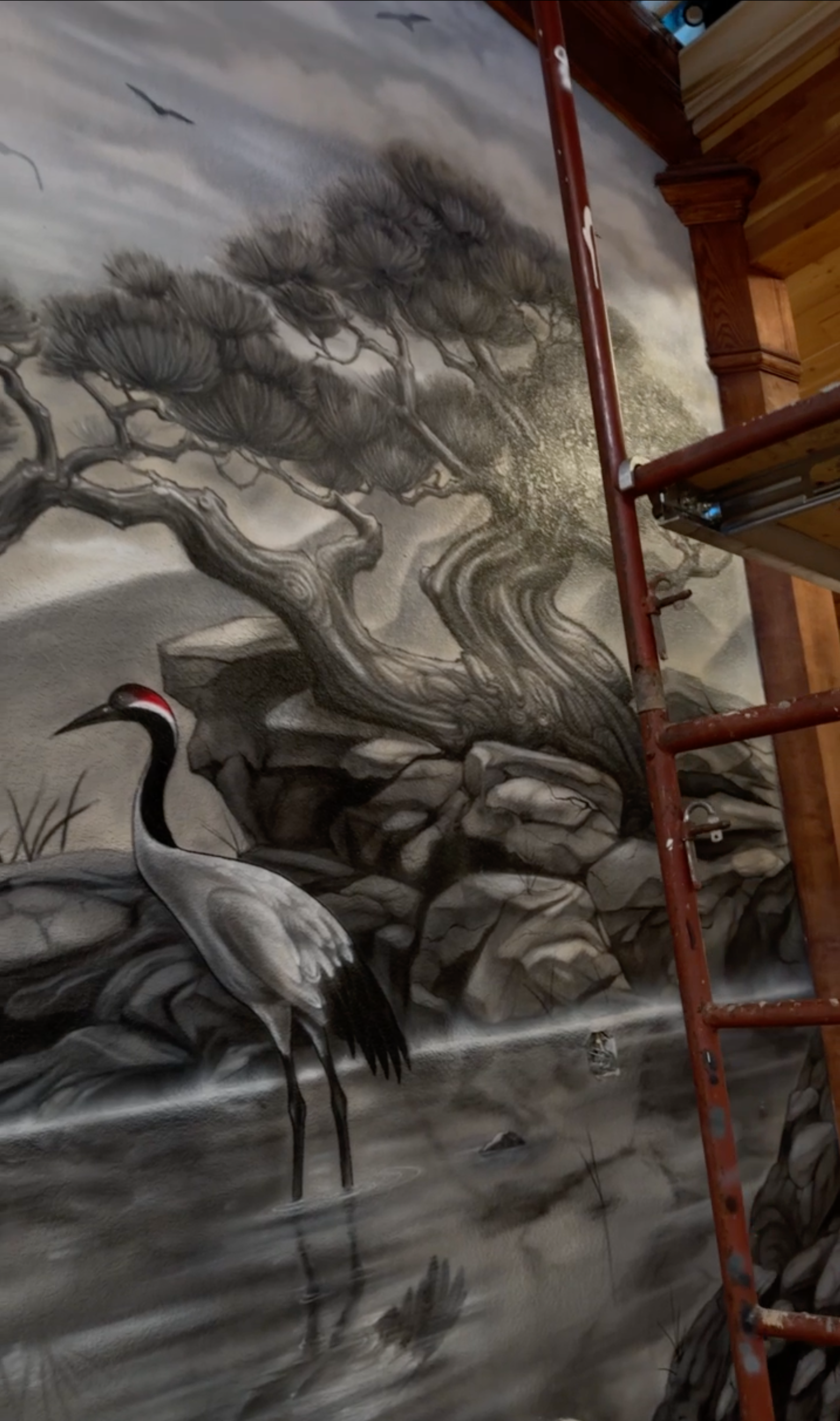 Detail of Bonsai tree and crane airbrush painting on Buddha wall