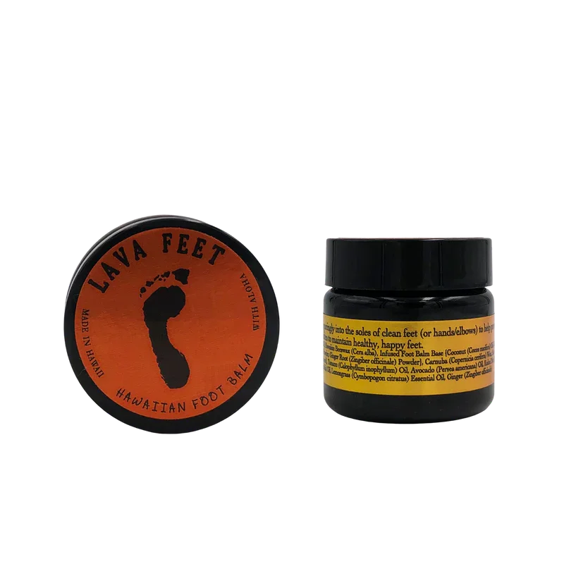 Two containers of Hawaii-themed foot or body balm. The left container has a circular orange label with a black silhouette of Hawaii, labeled 'Lava Feet' and 'Hawaiian Foot Balm'. The right container is a small black jar with a yellow label containing ingredients.