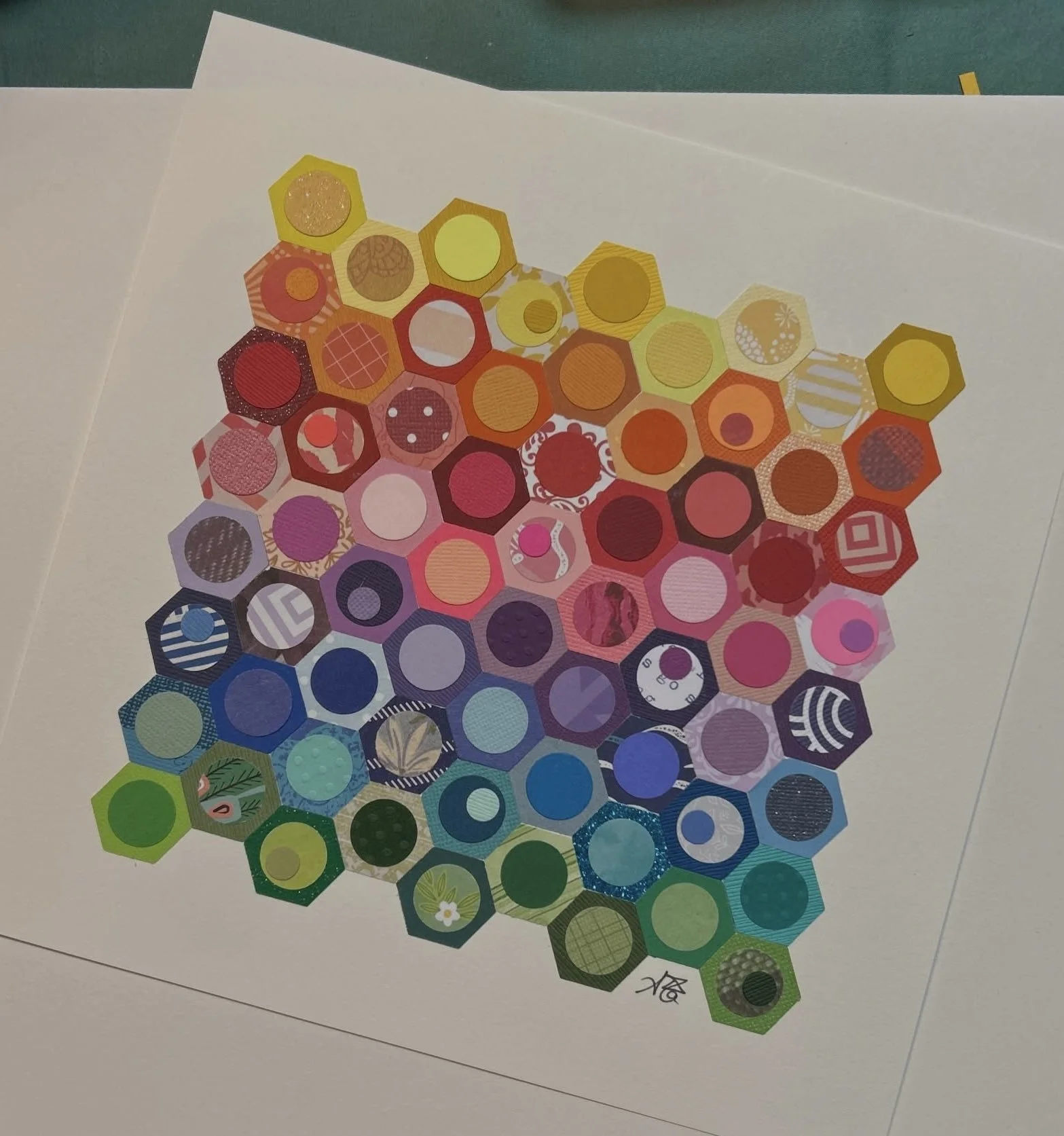 Colorful collection of hexagonal stickers arranged in a pattern on a white sheet of paper.