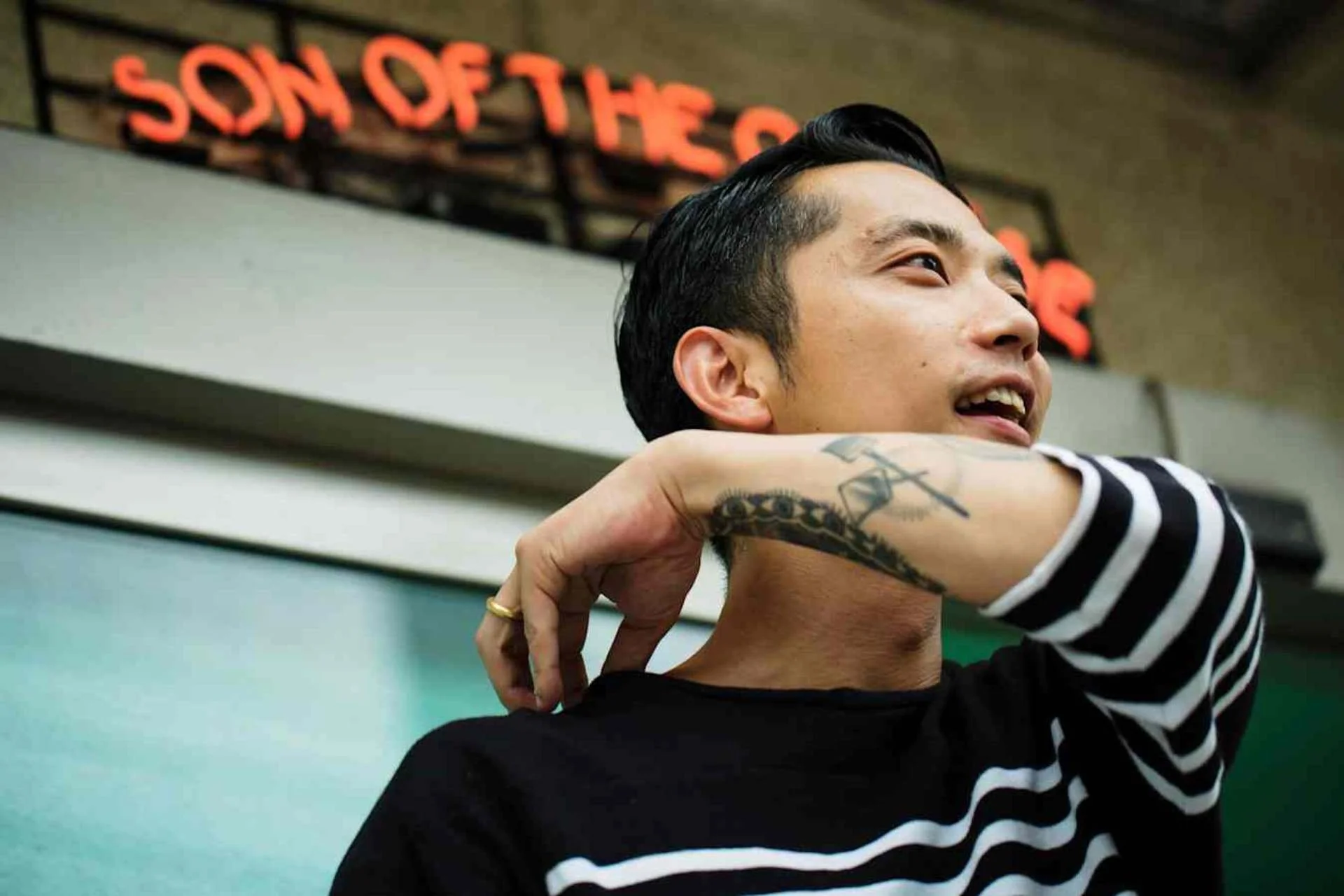 An image of brand founder and designer Kaito Yamamoto outside of his flagship store in Shibuya Tokyo, Son of the Cheese