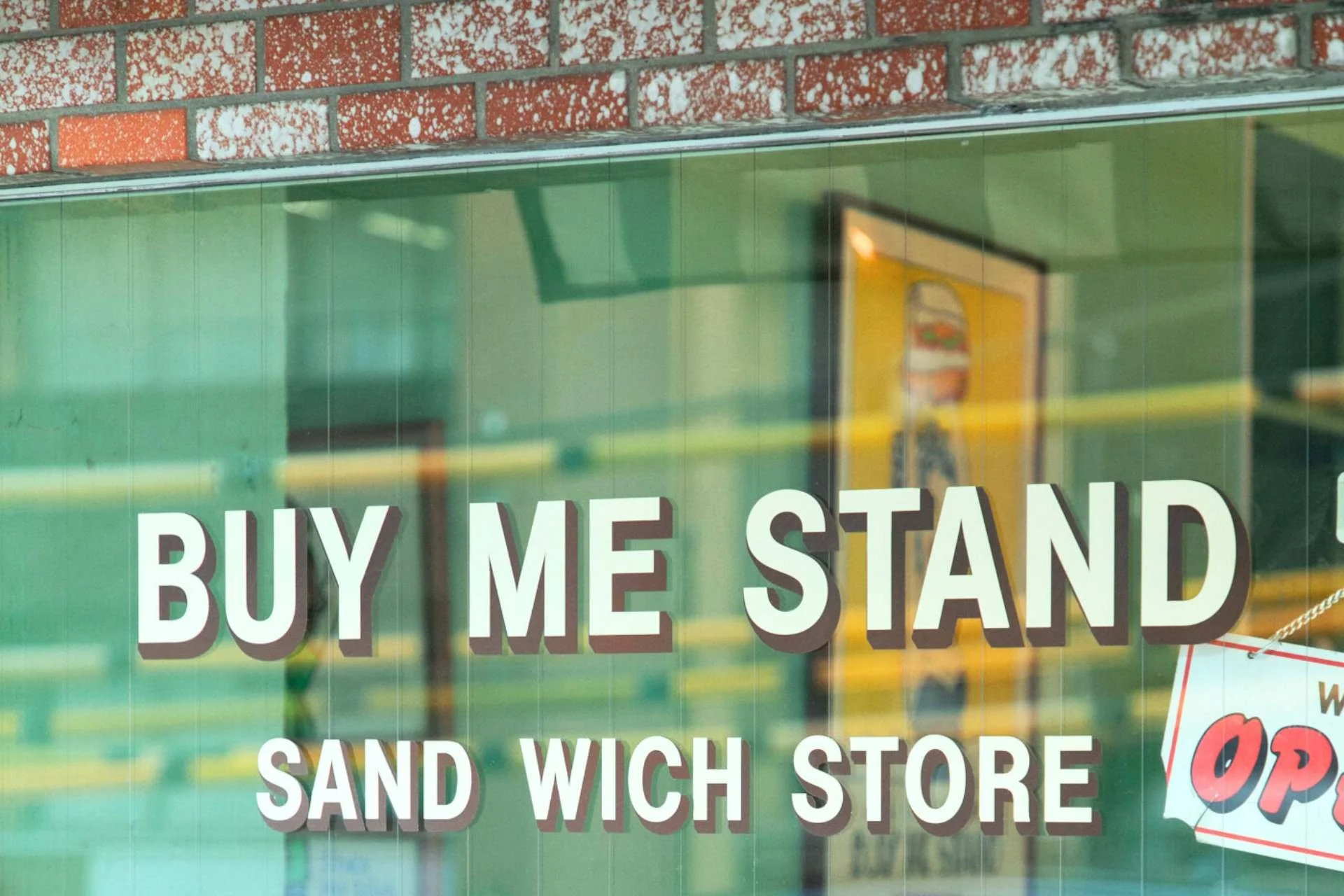 A photo of the painted windows at BUY ME STAND, Shibuya's premier breakfast spot and Japan's first successful grilled cheese sandwich shop.