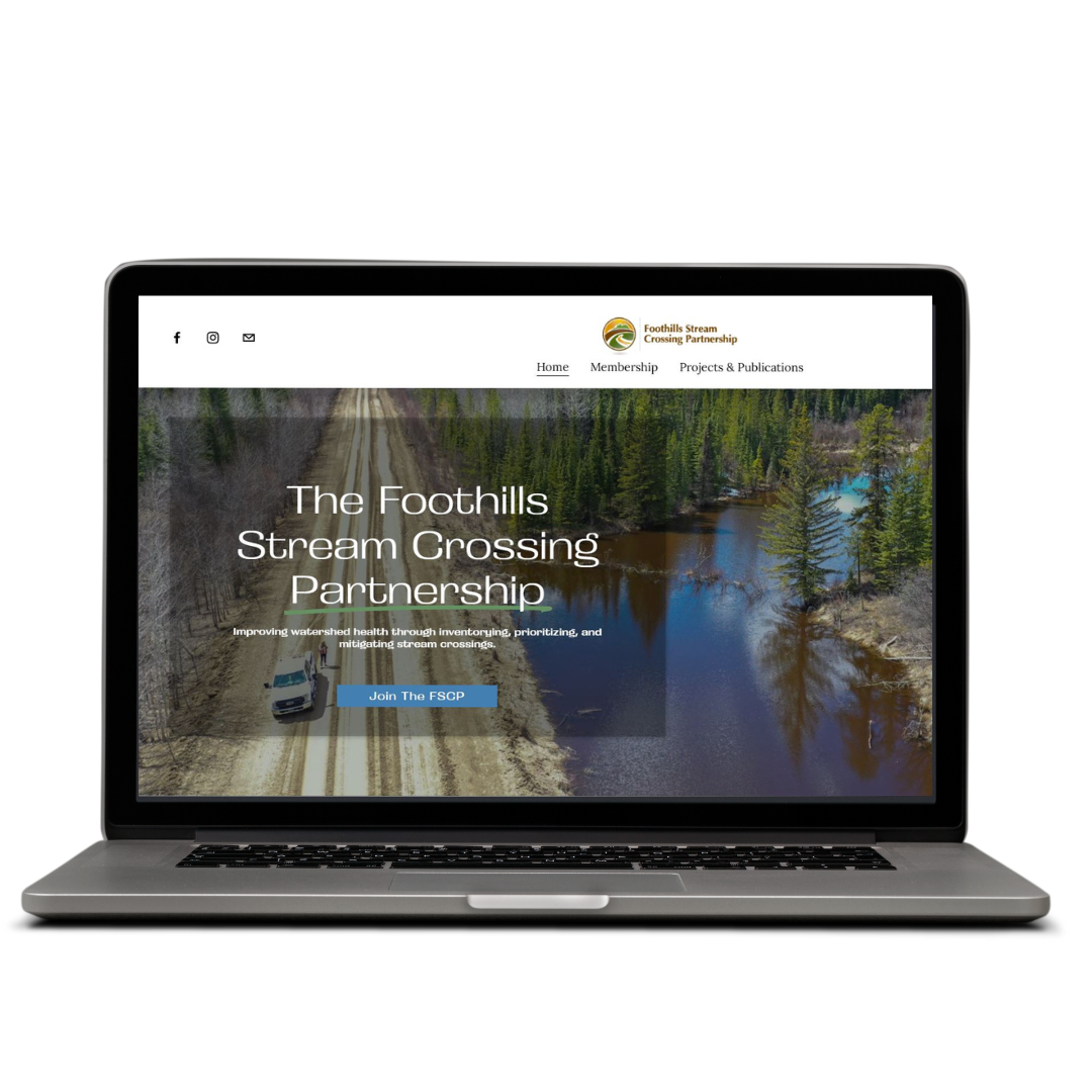 Laptop displaying the homepage of the Foothills Stream Crossing Partnership website with a background image of a riverside forest and a muddy road crossing a stream.