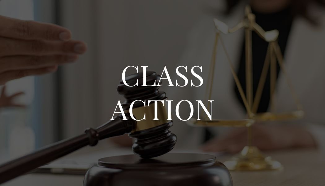 A gavel resting on a sound block, with a blurred figure of a person holding a set of scales in the background, and the words 'Class Action' overlaid.