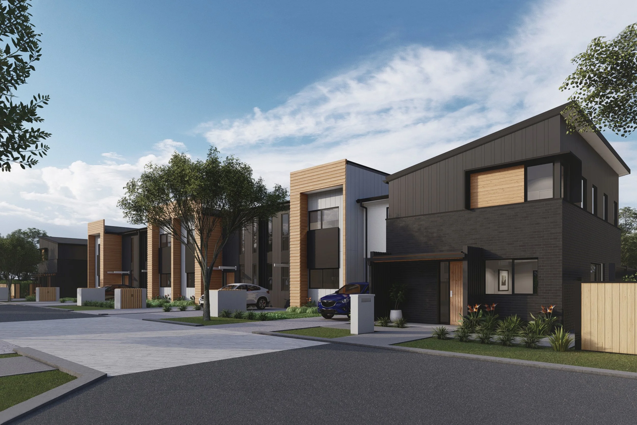 Modern residential houses in The Reserve's neighbourhood with cars parked outside, trees, and a partly cloudy sky.