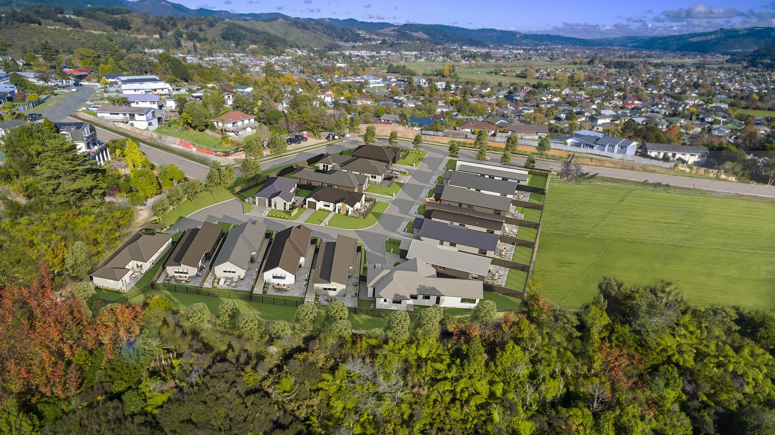 Aerial view of a Gillies Group's development, Brown Owl Park's residential neighbourhood with modern houses, green lawns, and trees, adjacent to open green fields and a distant hillside.