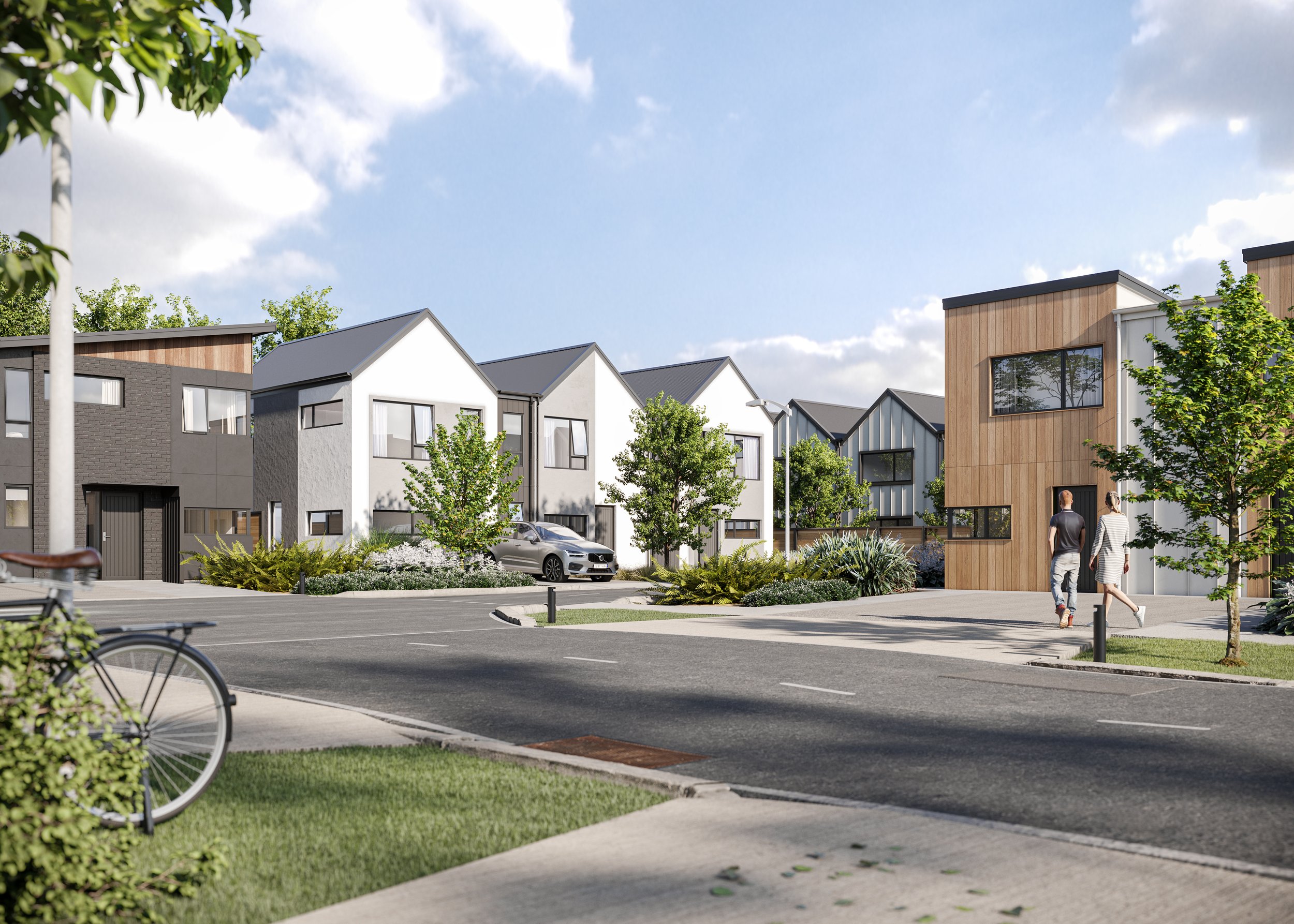Modern residential neighbourhood with contemporary houses, trees, and parked cars, under a partly cloudy sky.