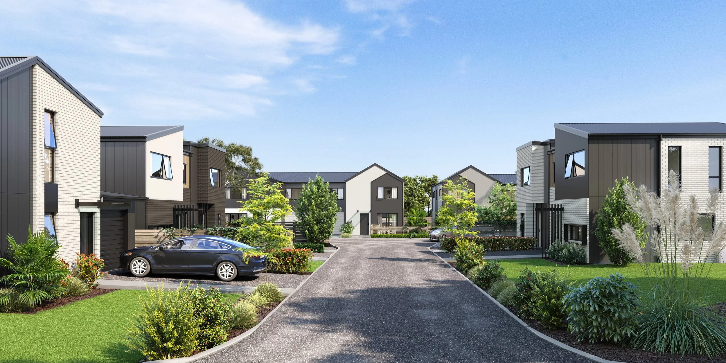Modern residential neighbourhood in Wallaceville Estate with contemporary townhouse-style homes, lush greenery, parked cars, and a clear blue sky.