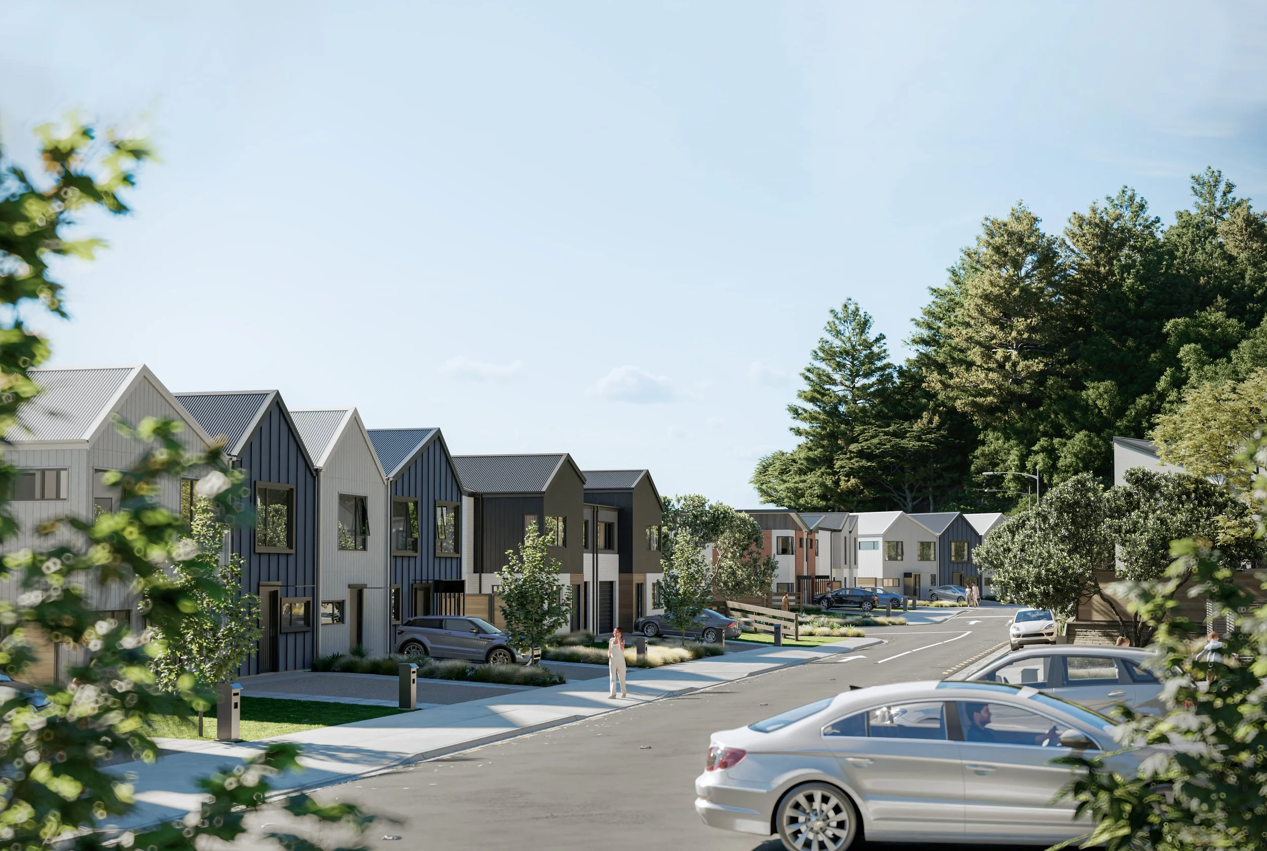 Modern residential neighbourhood render with a row of houses, parked cars, trees, and a person walking on the sidewalk under a clear blue sky.