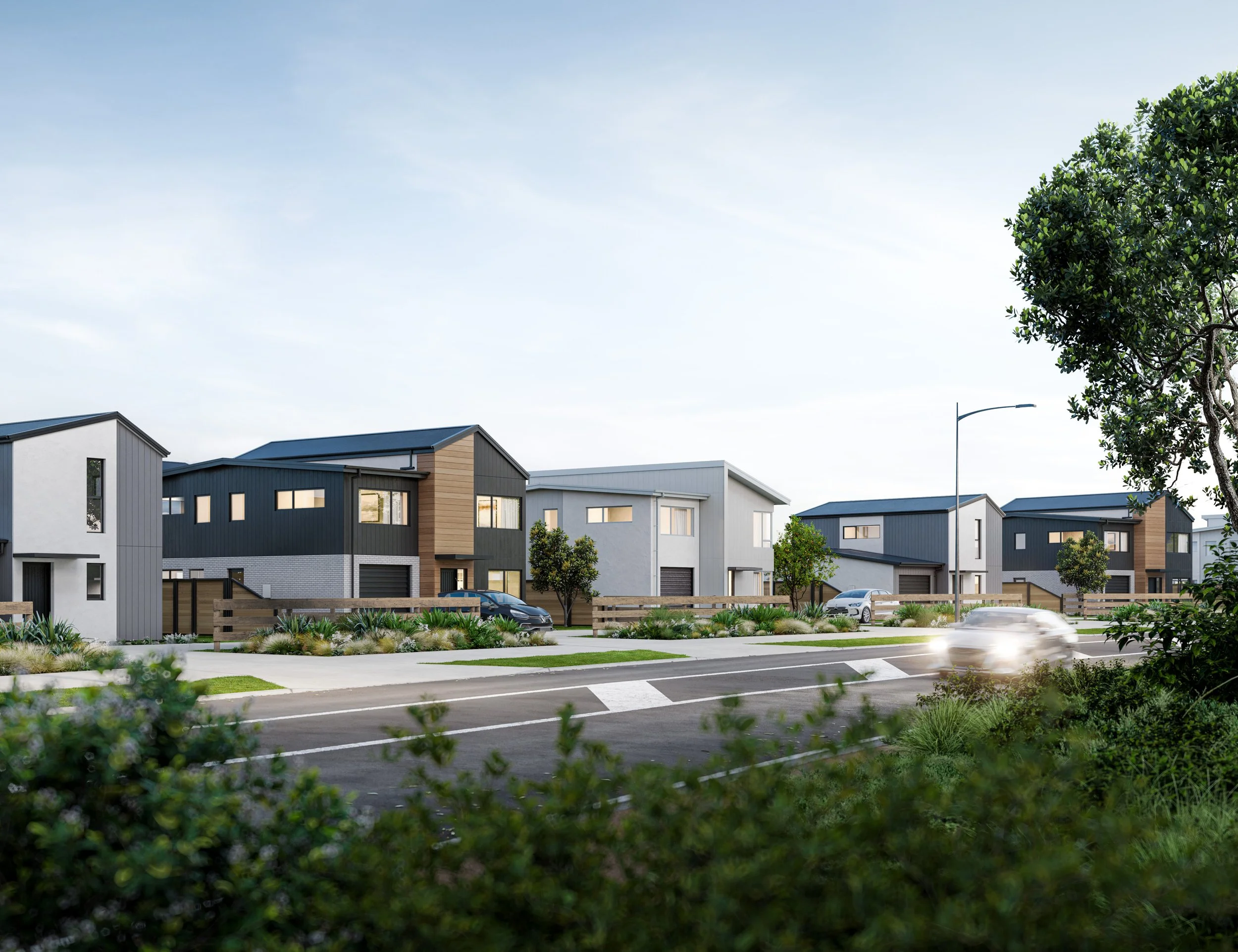 A render of Urban Precinct, Final Release, shows a row of modern houses in a suburban neighbourhood, with cars parked in driveways and a car driving past on the street, trees, greenery, and a clear sky.