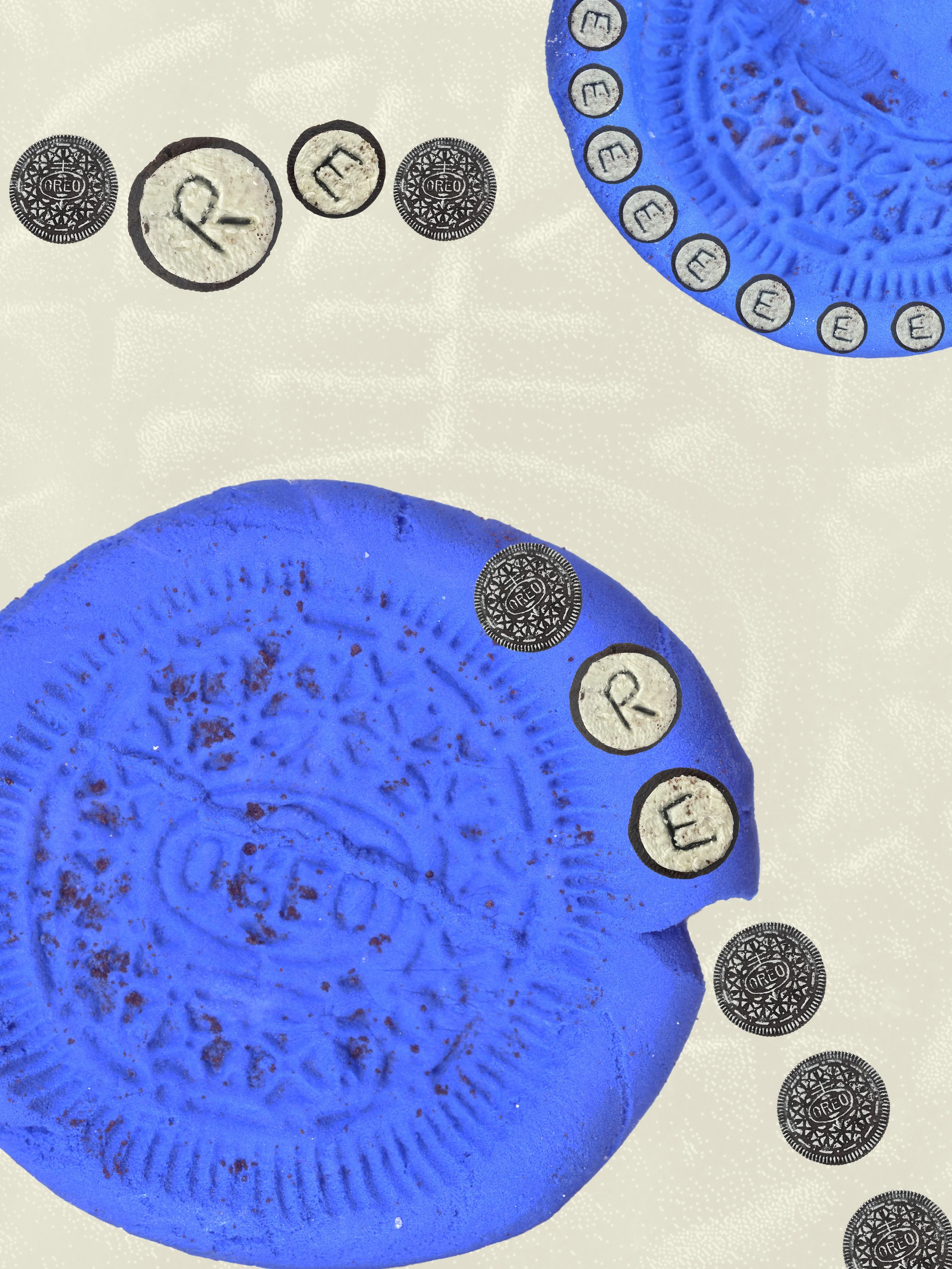 Close-up of two large blue Oreo cookies with embossed designs, surrounded by smaller Oreo images including partial views and individual symbols, on a white background.