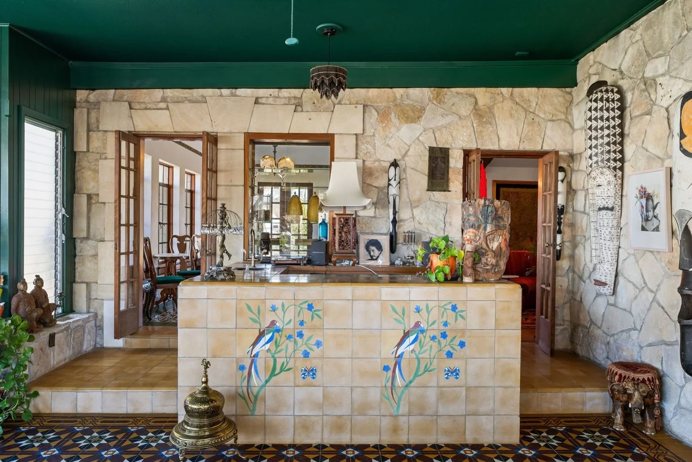 From open-air porch to enclosed solarium, now one of our favorite rooms.

You can still see the original stone exterior wall and the tiled bar (with birds) added by the Glosserman family in the late &rsquo;70s/&rsquo;80s (see the blue prints on the l