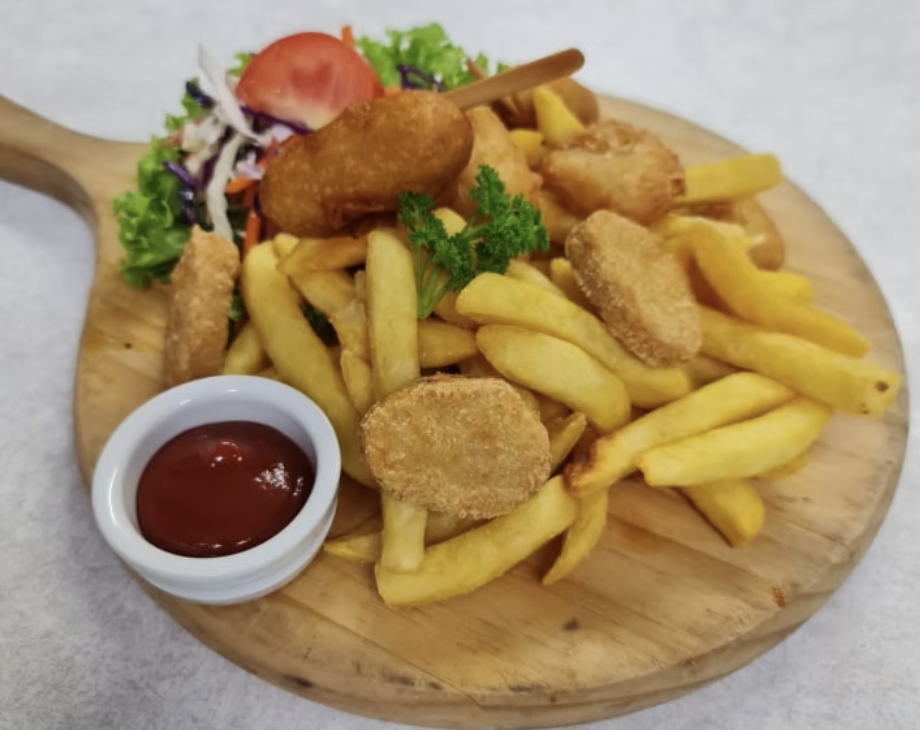 Kids platter at stone oven, including chips, nuggets, hotdog and salad.