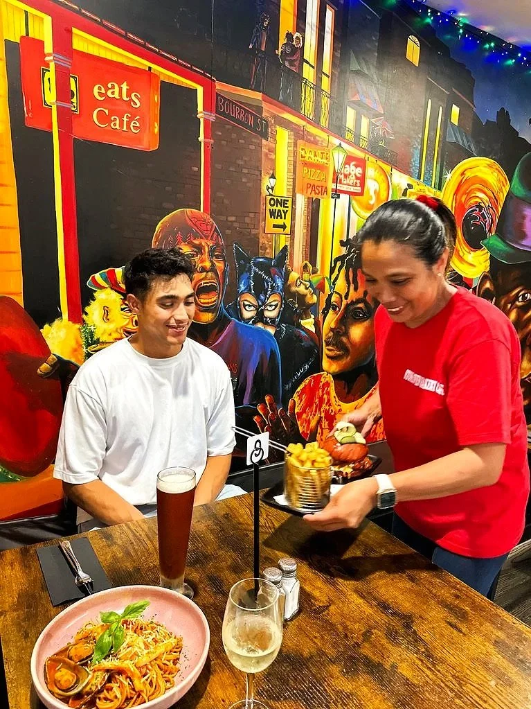 Stone oven bakery & restaurant customer being served their meal in hokitika