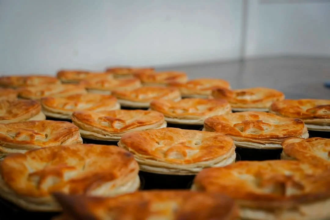 A tray of freshly baked savory pies or pastries from stone oven bakery and cafe restaurant in Hokitika