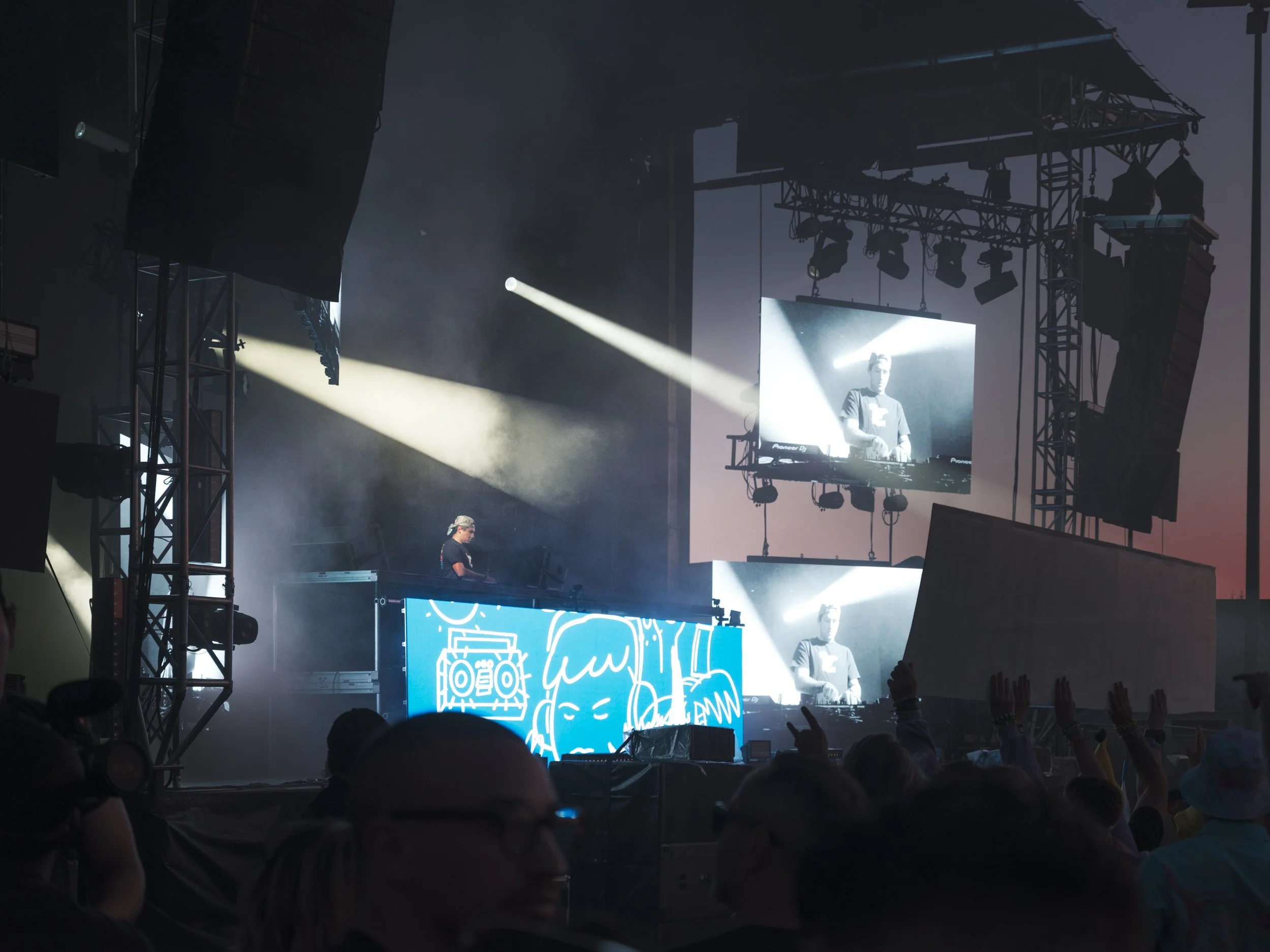 Concert crowd facing an illuminated stage during Unity Electrofëst live music coverage