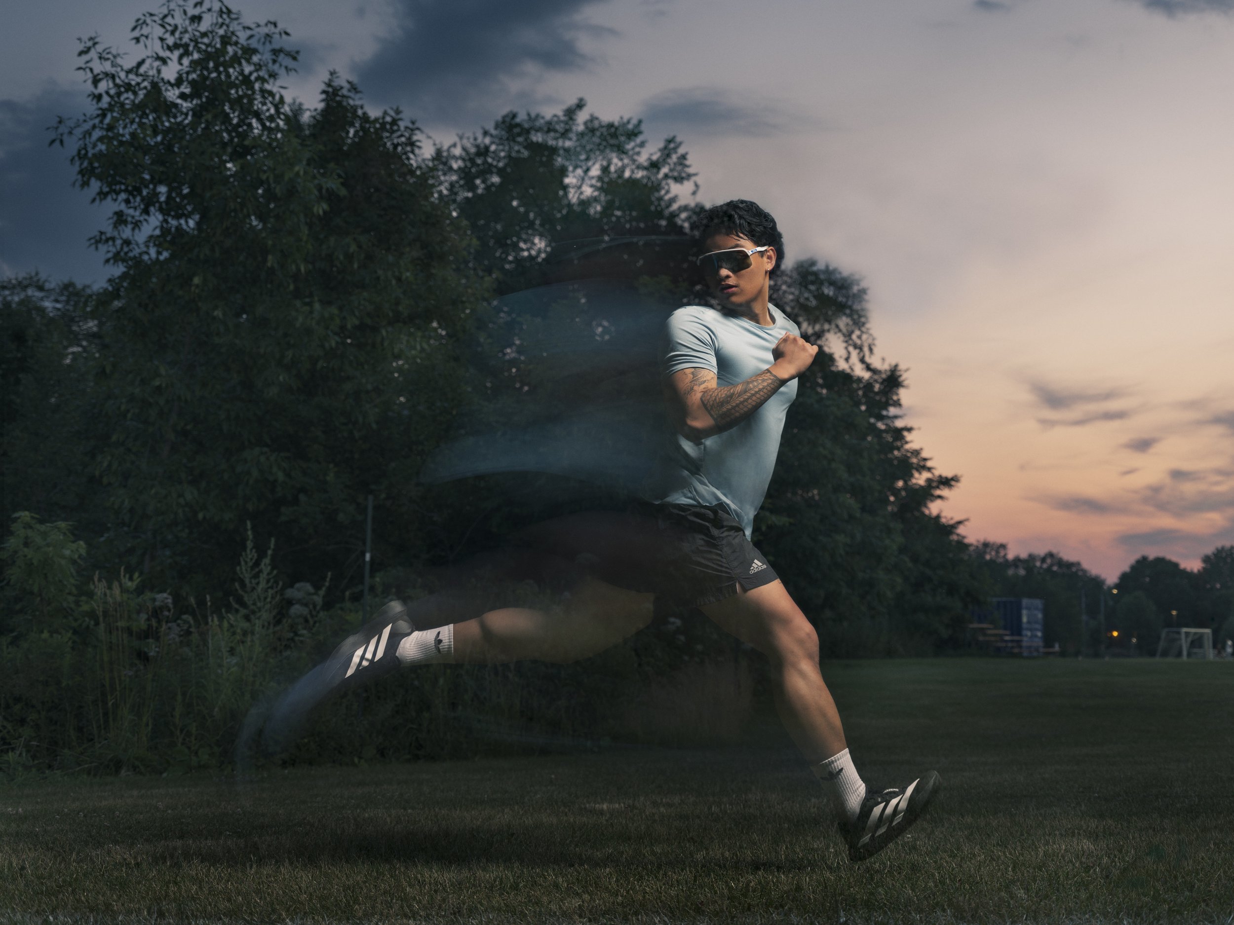 Sportswear fashion campaign photograph with a model in motion at sunset