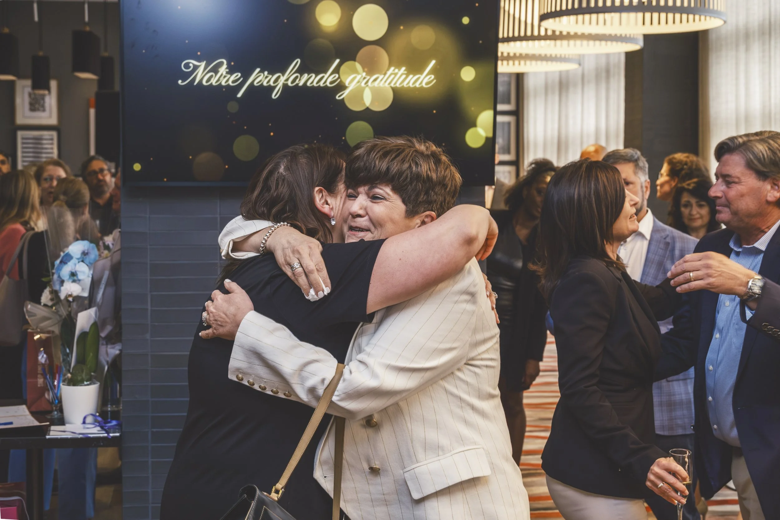 Emotional candid hug during Mirella retirement party coverage