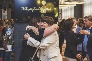 Emotional candid hug during Mirella retirement party coverage