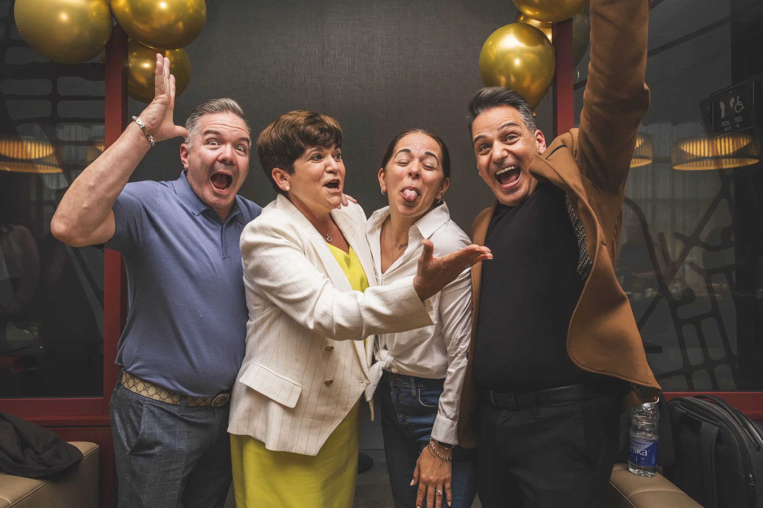 Guests celebrating with raised arms during Mirella retirement party photography