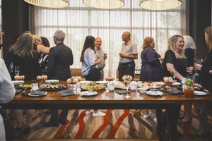 Guests enjoying food and conversation during Mirella retirement celebration