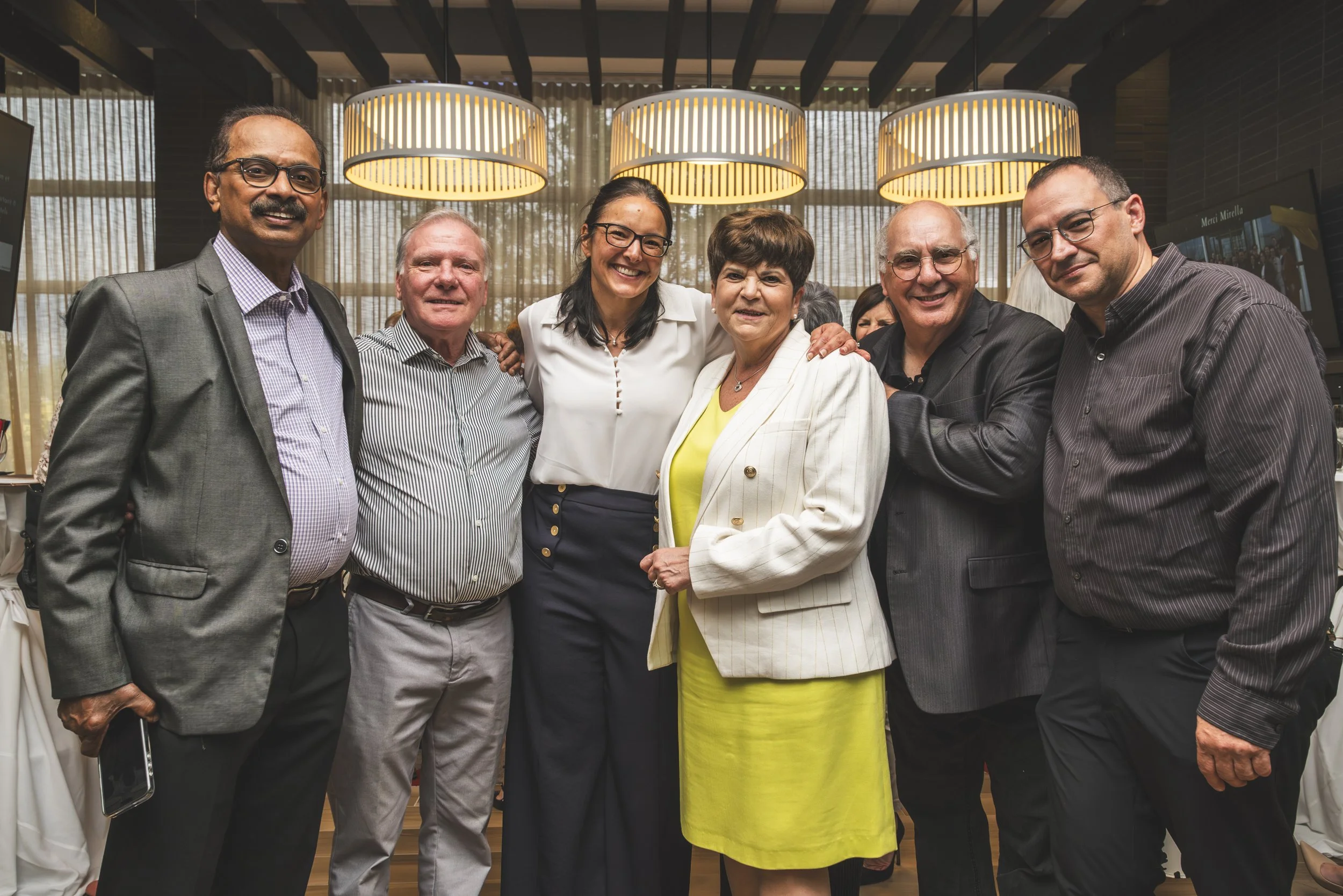 Family and colleagues gathered for a retirement celebration portrait