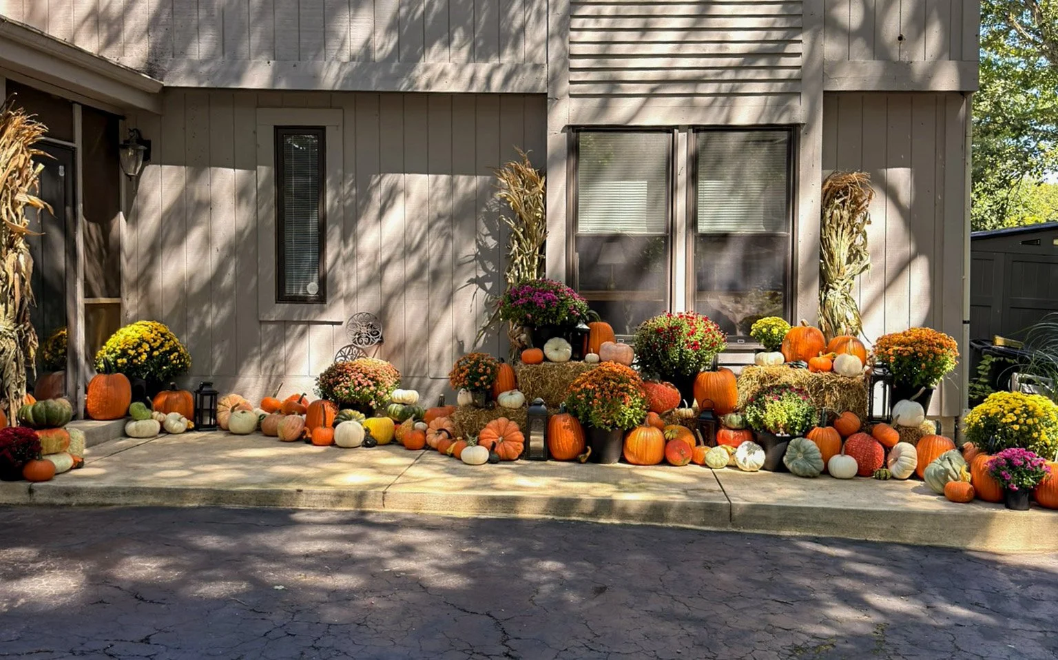 Premier Fall Collection spanning a wide Columbus entrance with corn stalks, mums, lanterns and pumpkins