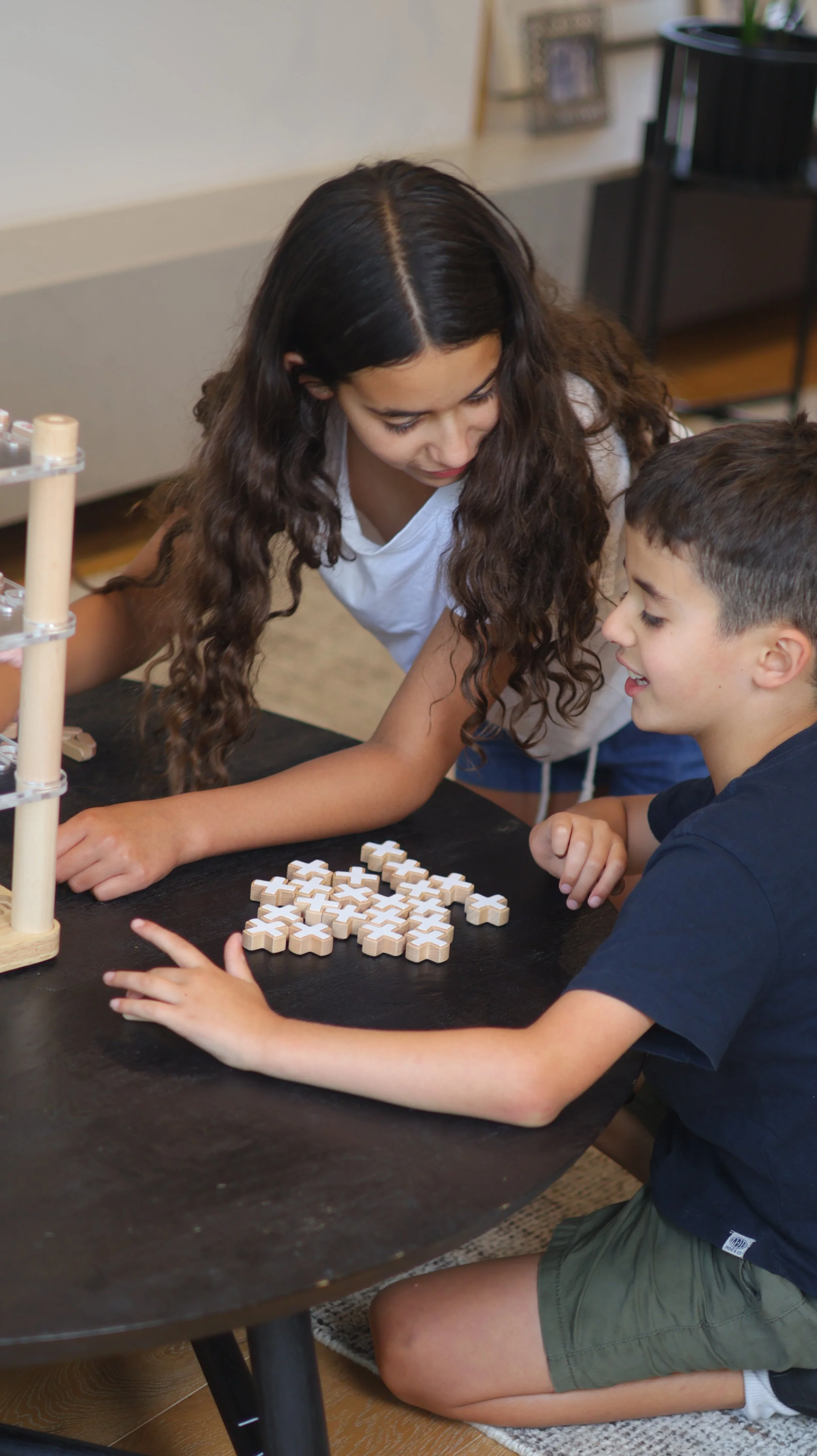 Family playing strategy board game together at home