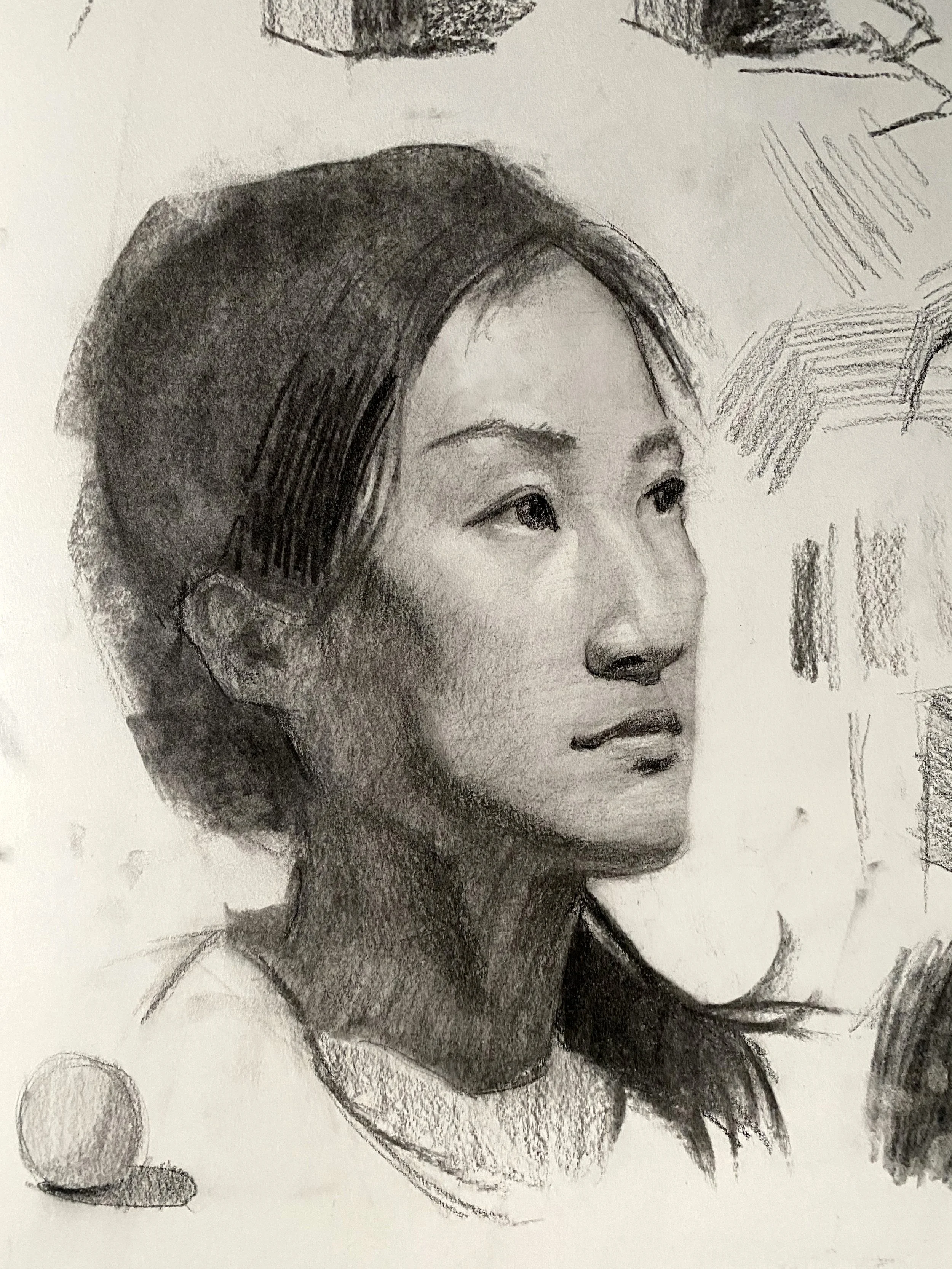 A black and white pencil sketch of a woman's face in profile, showing her nose, lips, and eye, with some abstract geometric shapes and shading around her head.
