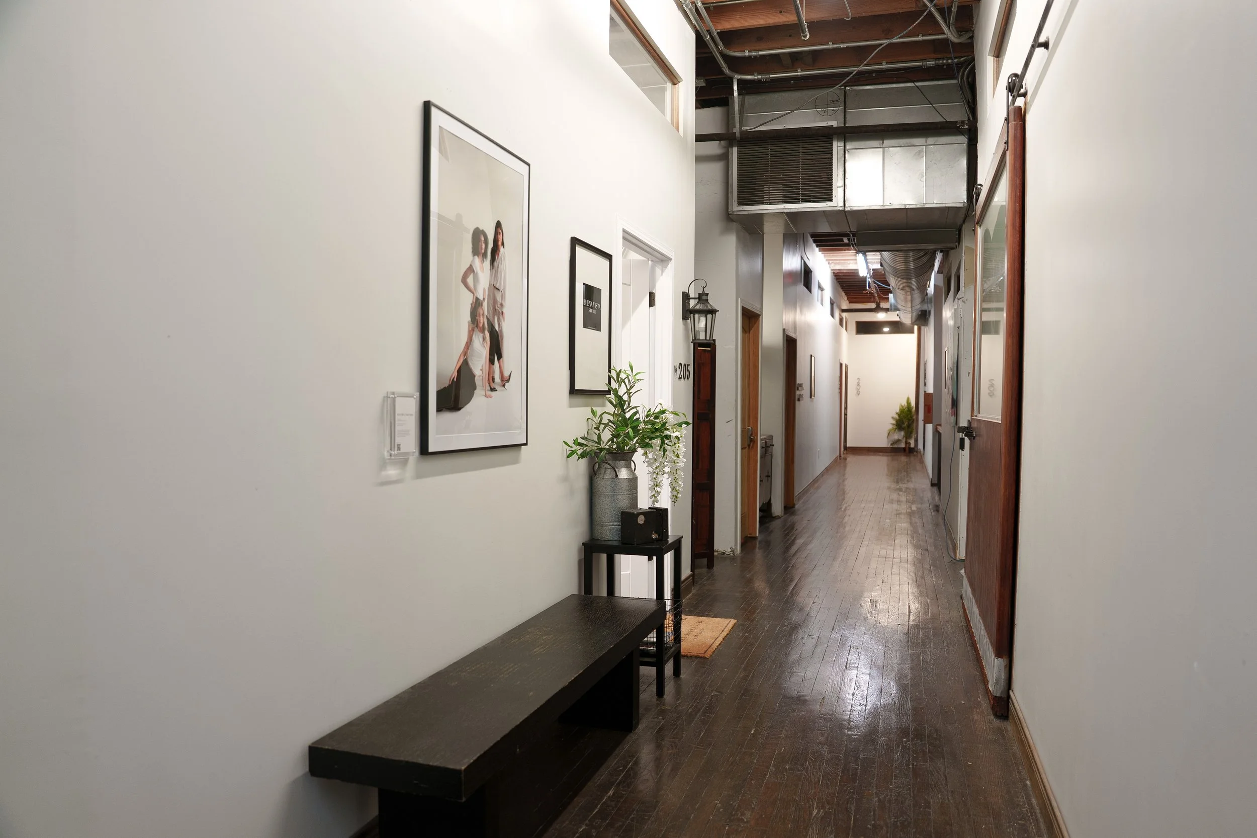 Framed Photo of the Month display inside Buena Vista Studio, a natural light photography studio and creative rental space in downtown San Antonio, Texas.