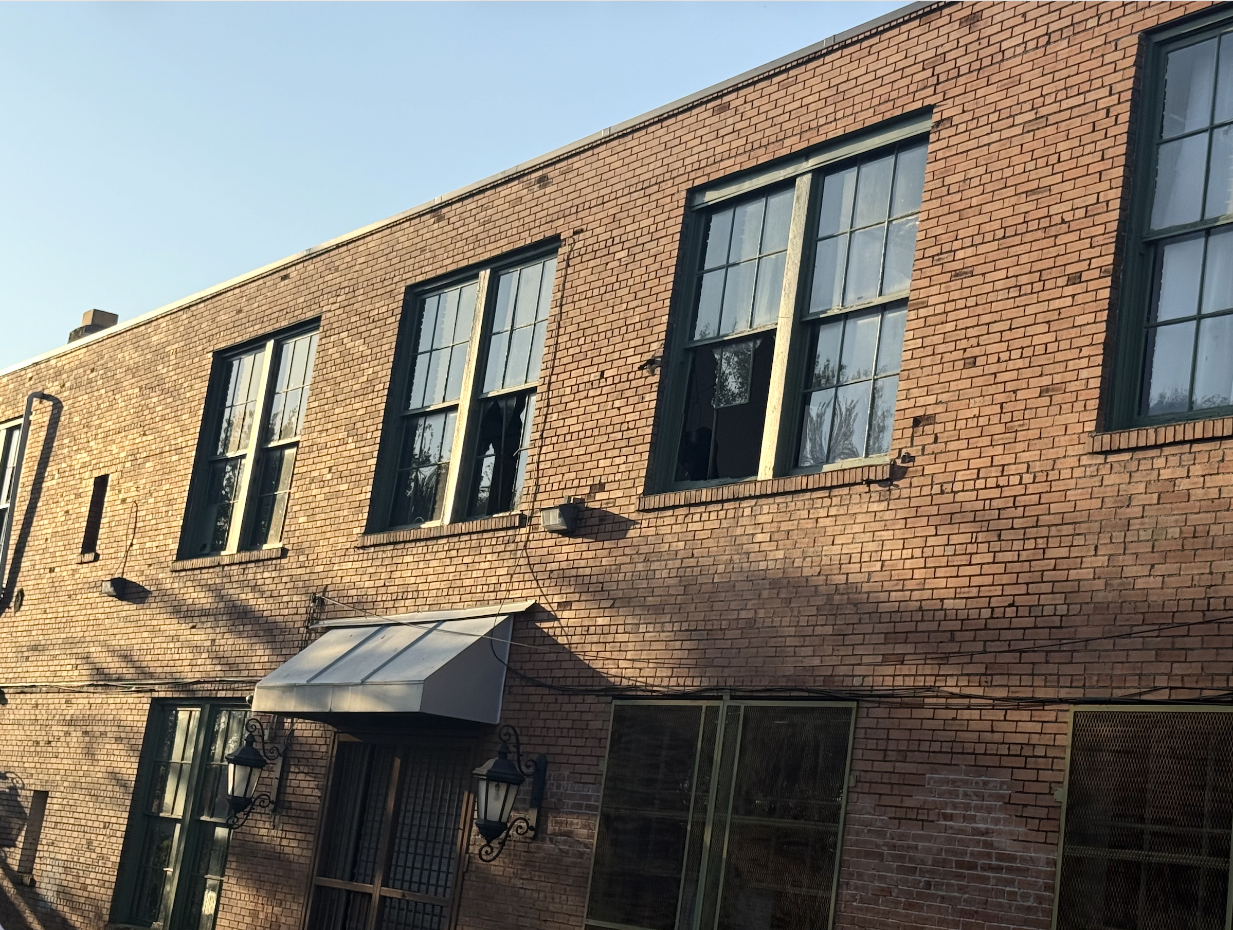 Storm-damaged industrial windows at Buena Vista Studio inside Warehouse 5 in San Antonio
