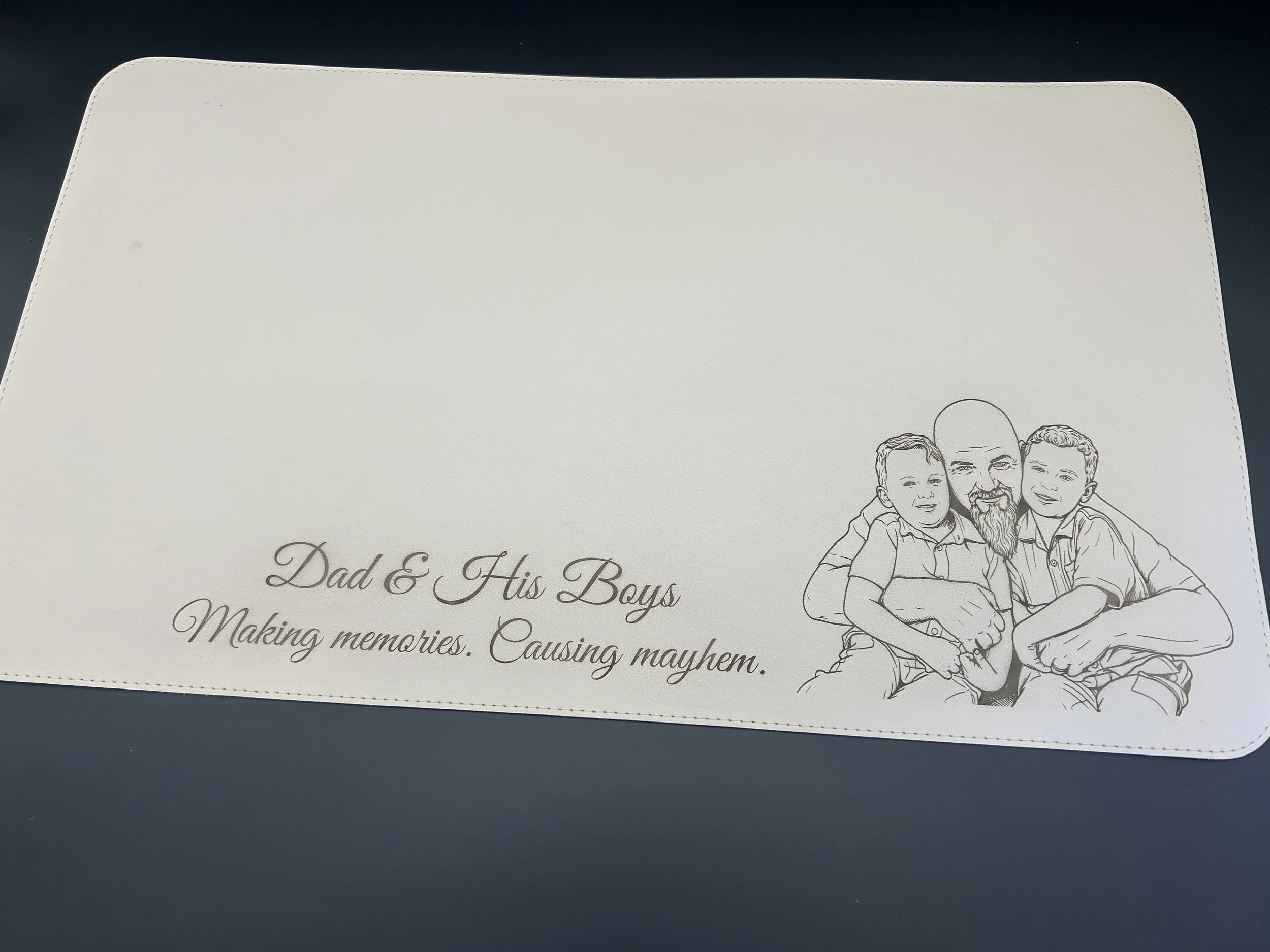 Beige PU leather desk mat engraved with father and sons portrait and custom text