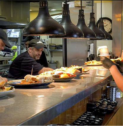 Chefs working in the kitchen inside Pottery House Cafe