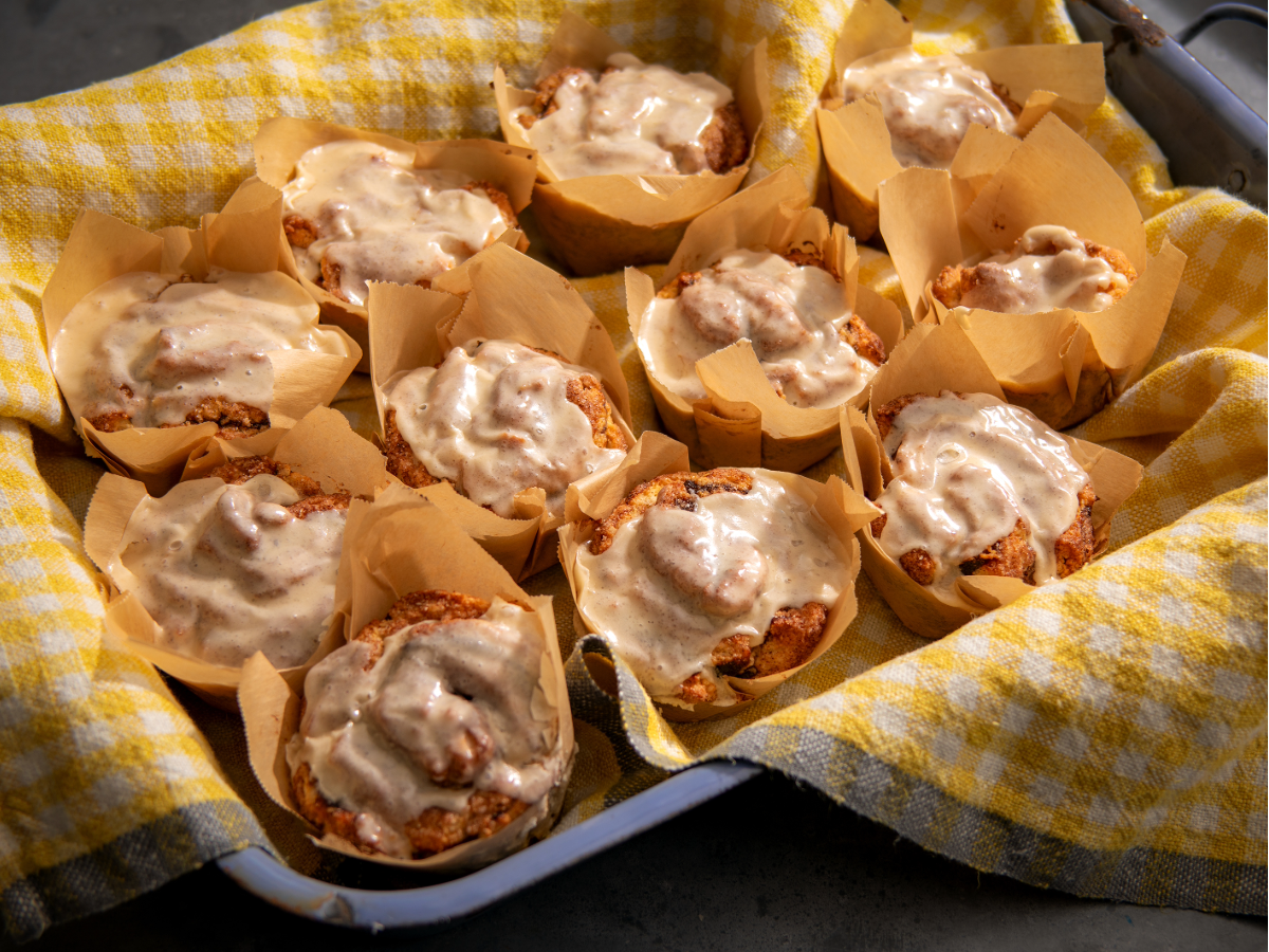 Apple Butter Cinnamon Muffins in kraft paper tins in a basket.