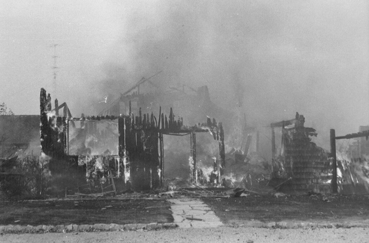 Black and white historic photo of The Old Mill on fire