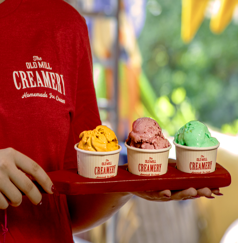 Close-up of a flight featuring three flavors of freshly scooped ice creams in cups at our Pigeon Forge shop.