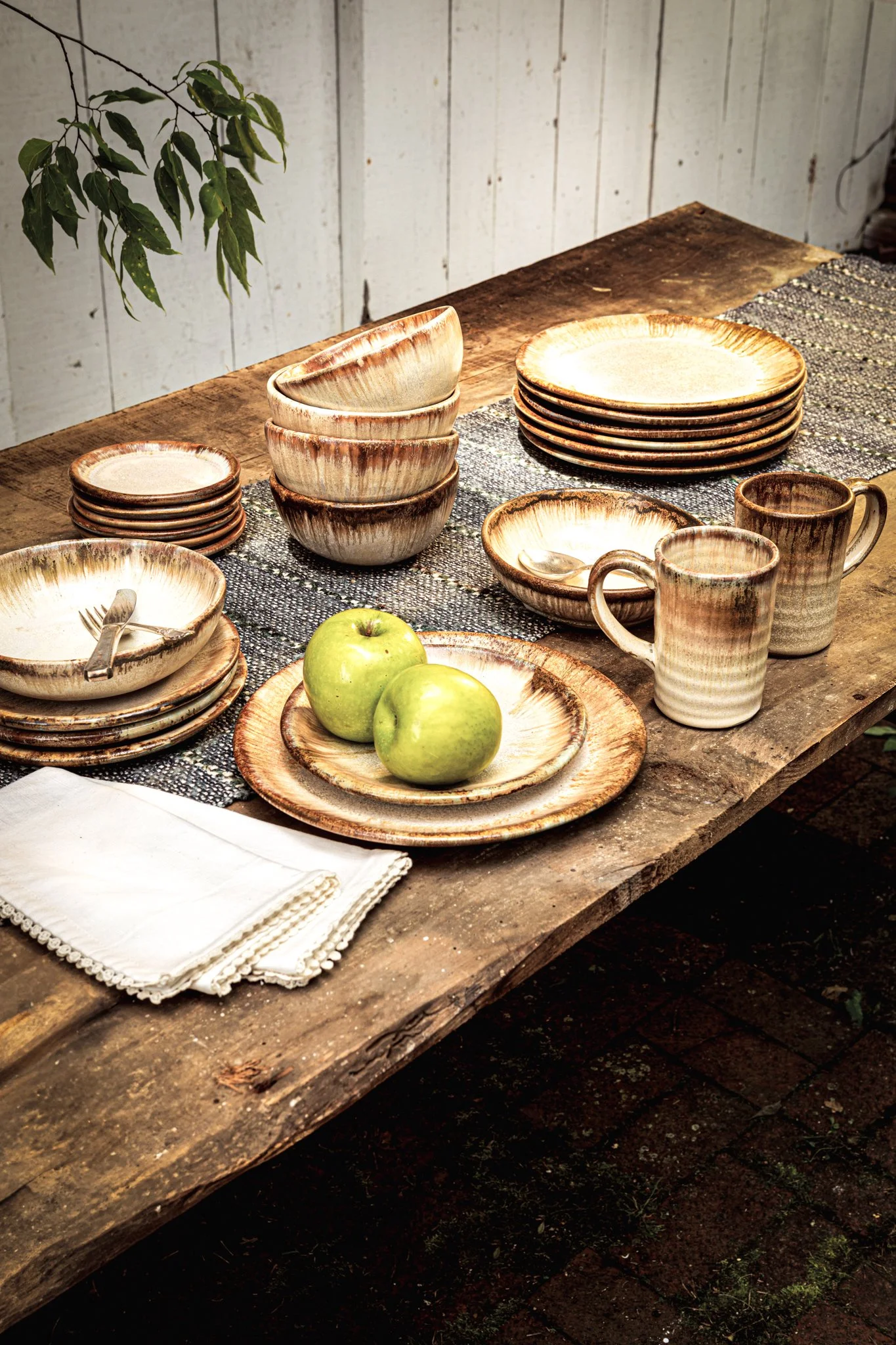 Various pieces of dinnerware in Batter Bowl in Flowering Dogwood glaze from Pigeon Forge Pottery