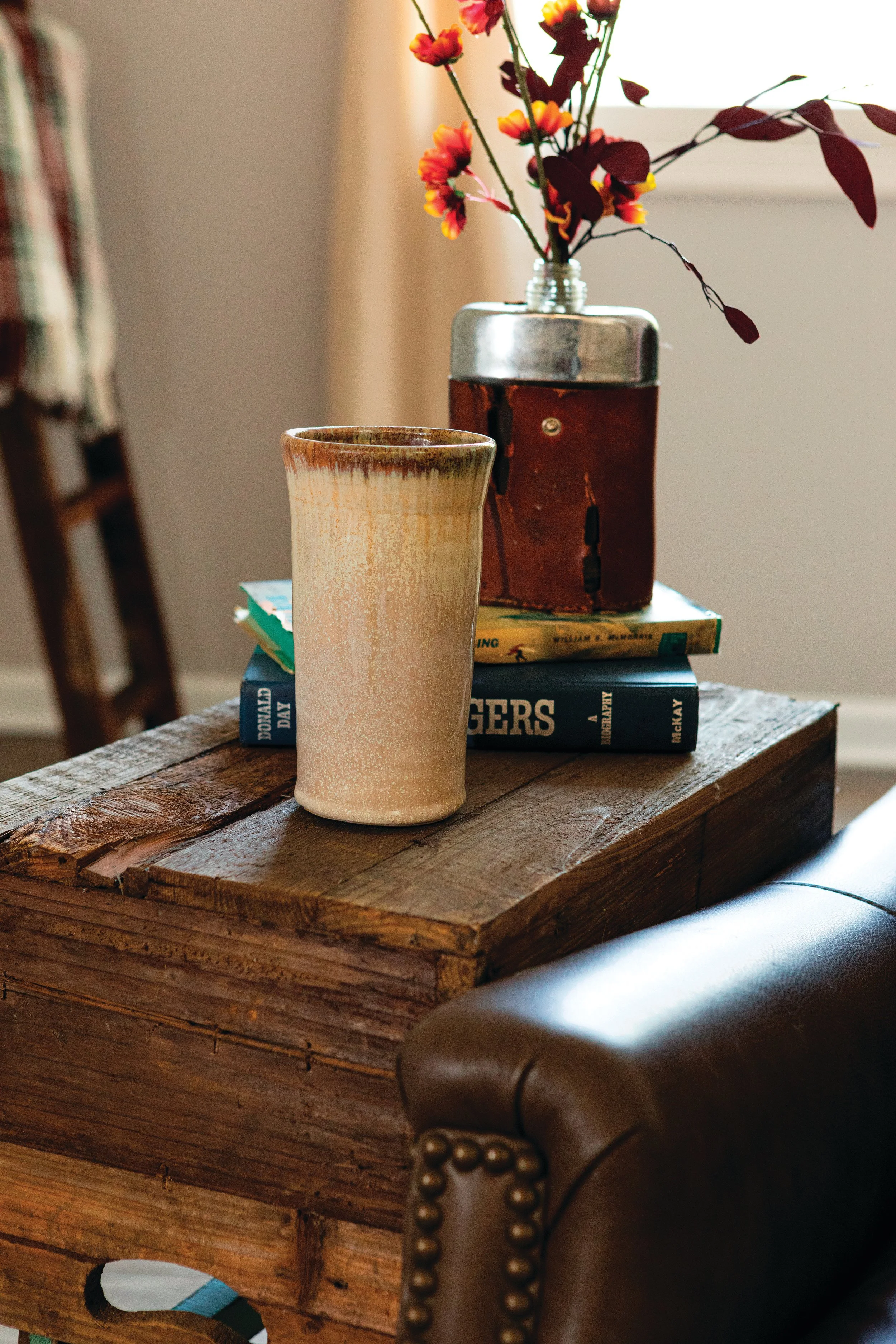 Coffee mug in Flowering Dogwood glaze on a vintage table with books