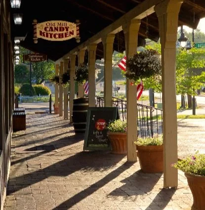 Outside porch of the Candy Kitchen in the warm glow of the Pigeon Forge sunrise