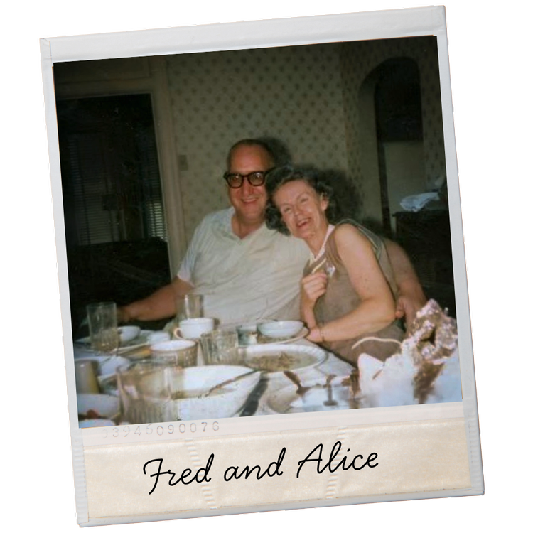 Grandparents at dinner table in 1960s. (Fred and Alice) Table is full of dishes with a tablecloth.