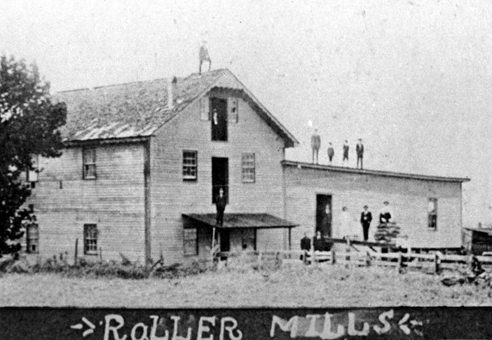 Black and white historical photo of the "Roller Mills" building