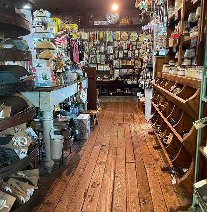 Aisles in the General Store show an assortment of goods and it's beautiful wood floor