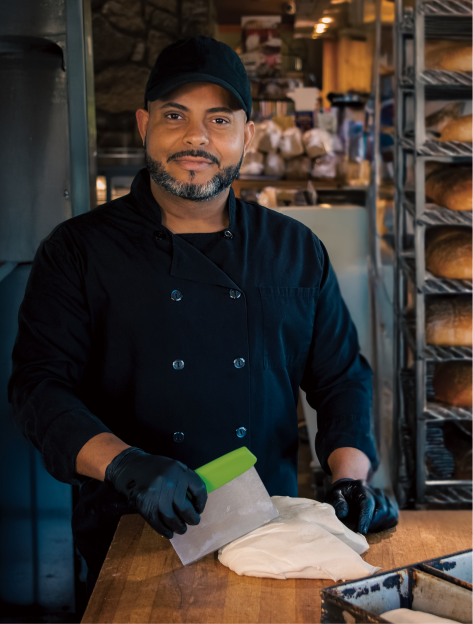 Photo of a baker working in the Potter House Cafe