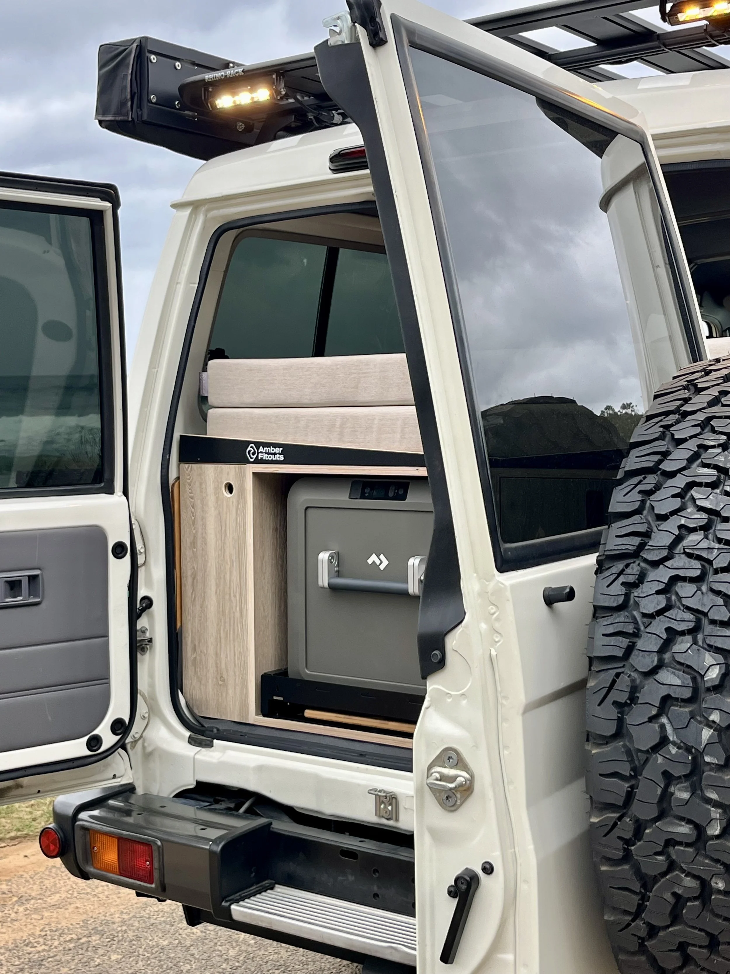 Toyota Landcruiser Troopcarrier camper interior with custom upholstery and timber cabinetry