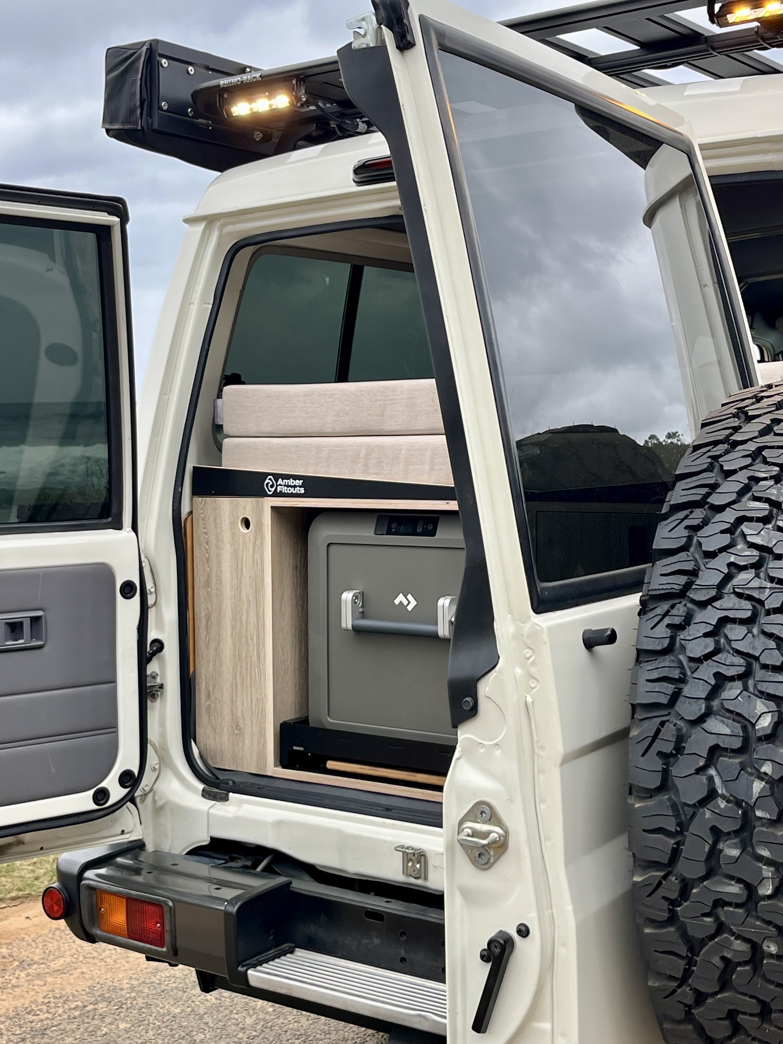 Toyota Landcruiser Troopcarrier camper interior with custom upholstery and timber cabinetry