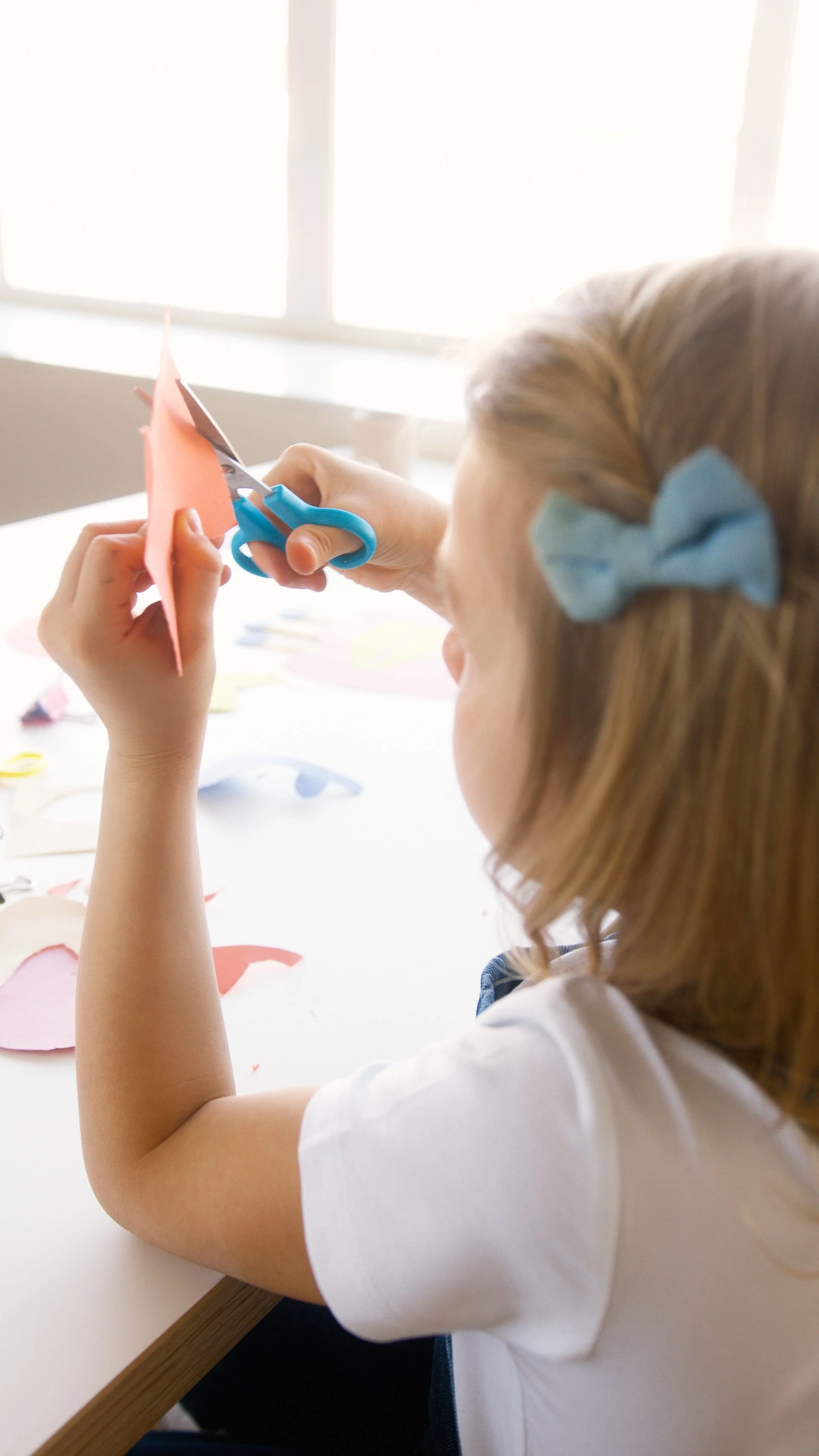 Preschool child working at classroom tables during structured early learning activities in Calgary