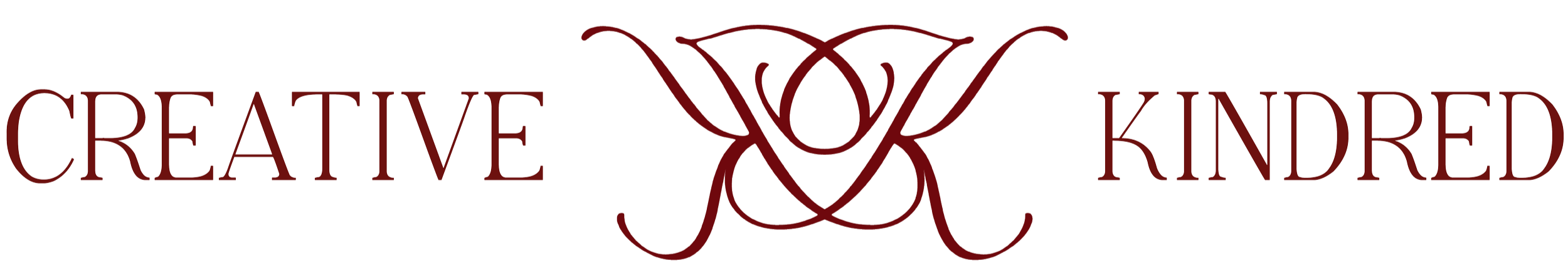 The text 'Creative Kinder' with an ornate floral design between the words.