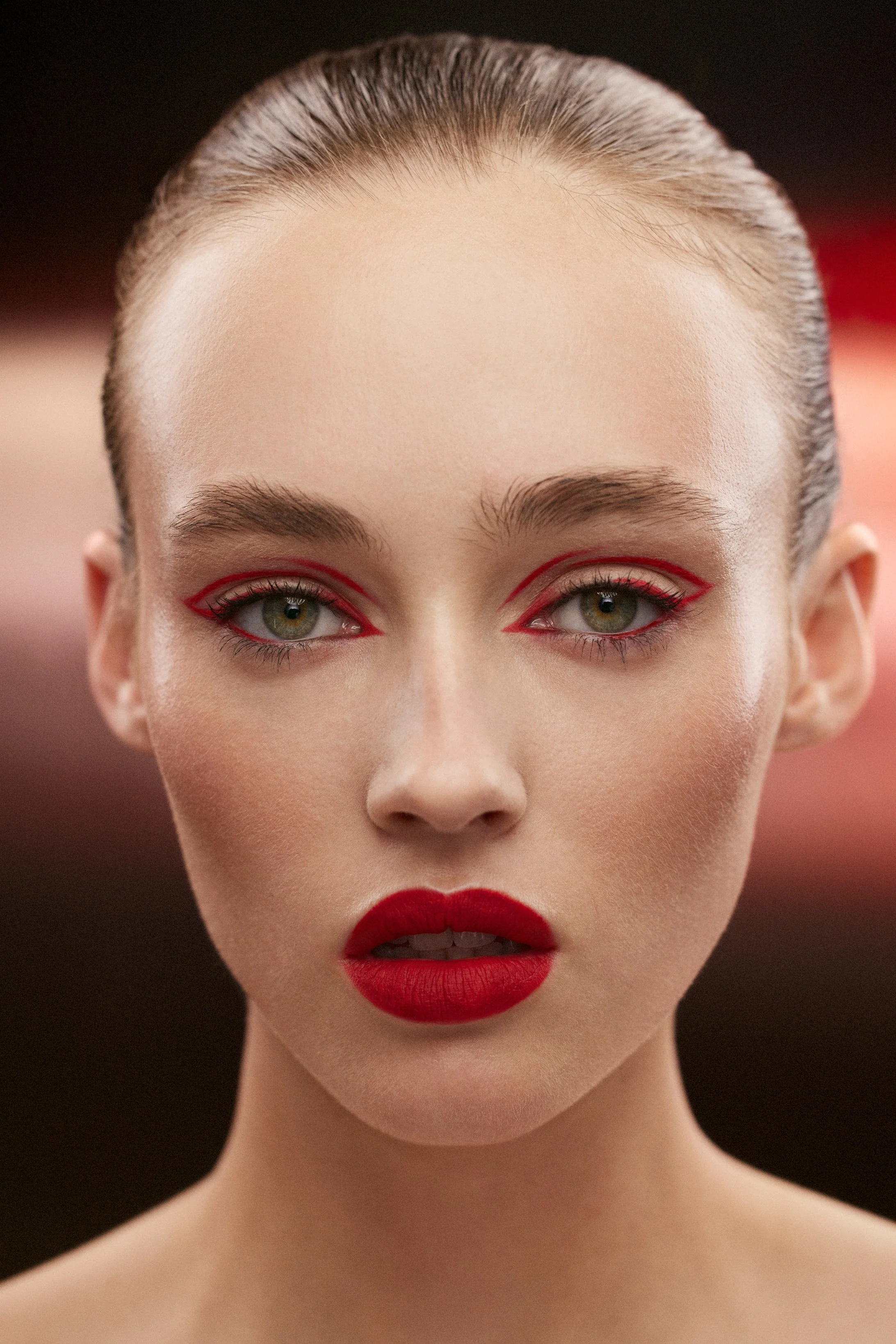 A beauty portrait of a female model with red lipstick and eye liner